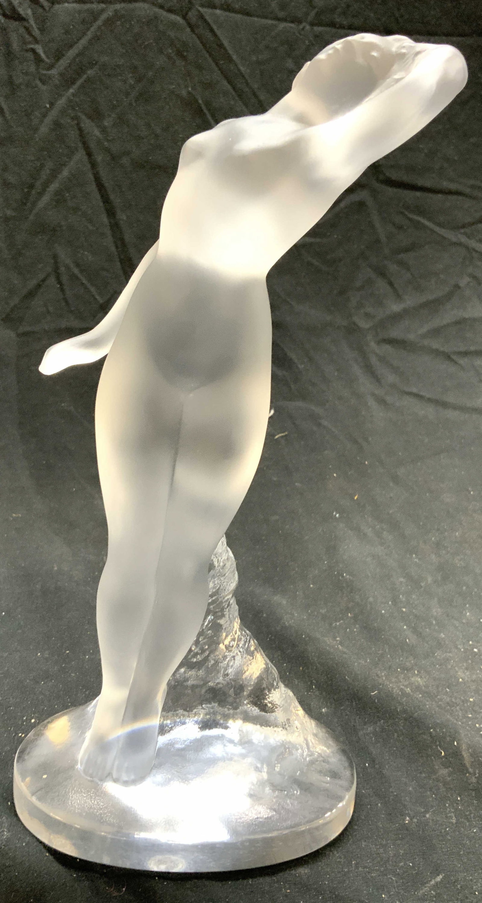 LALIQUE FRANCE Danseuse Bras Leves Female Nude: Underside signed LALIQUE FRANCE. Danseuse Bras Leves sculpture, designed 1960, depicts a nude woman dancing in frosted and translucent crystal. Measures approximately 9.5in H x 4in W x 3.5in D. Laliqu