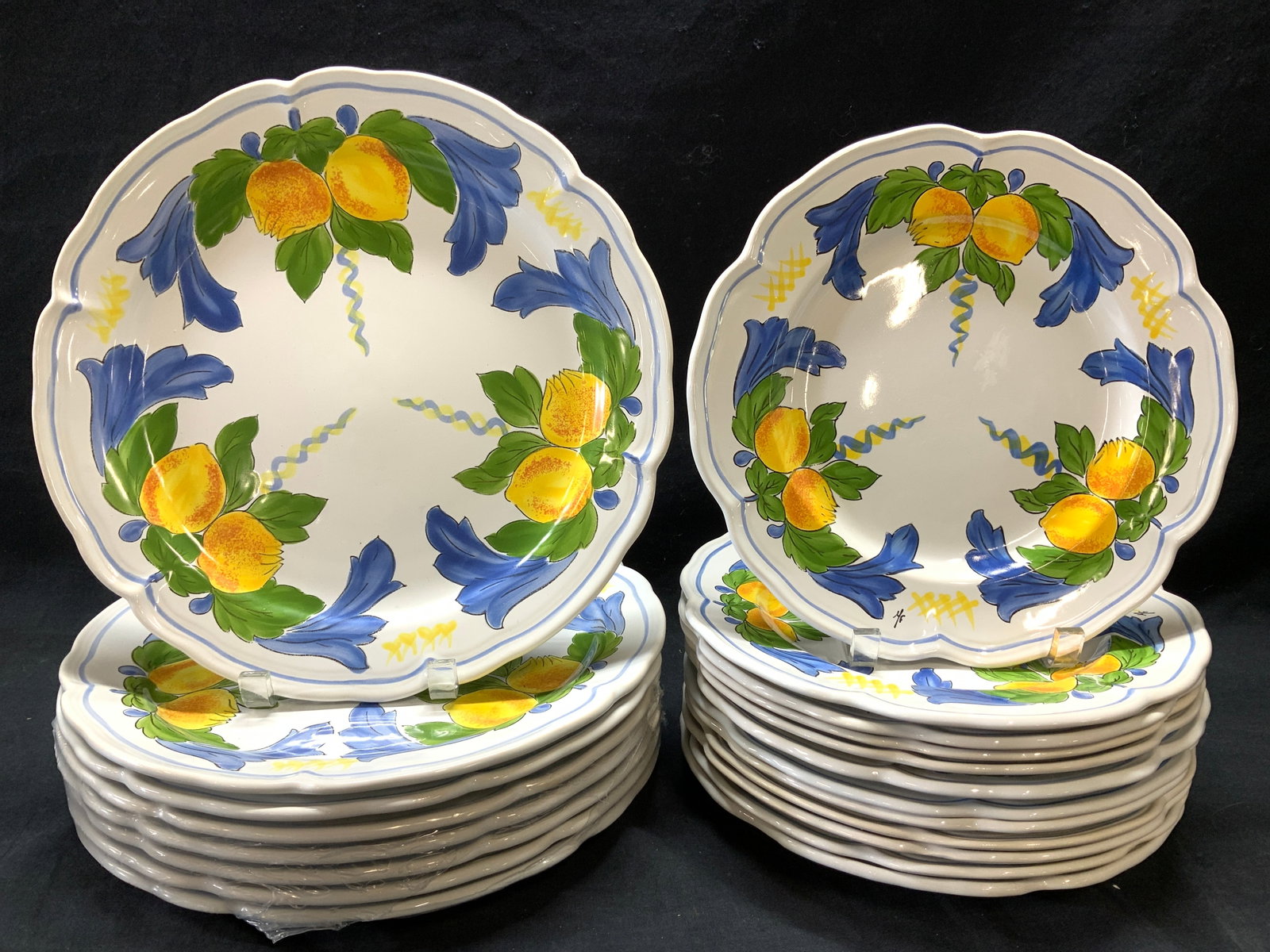 Set 20 Pornic French Heritage Porc Plates, France: Hand painted French porcelain plates and charger plates. Hand painted with brilliant yellow lemons accented with green and blue leaves on a white background. 8 chargers. Chargers measure 12 in. 5 are 