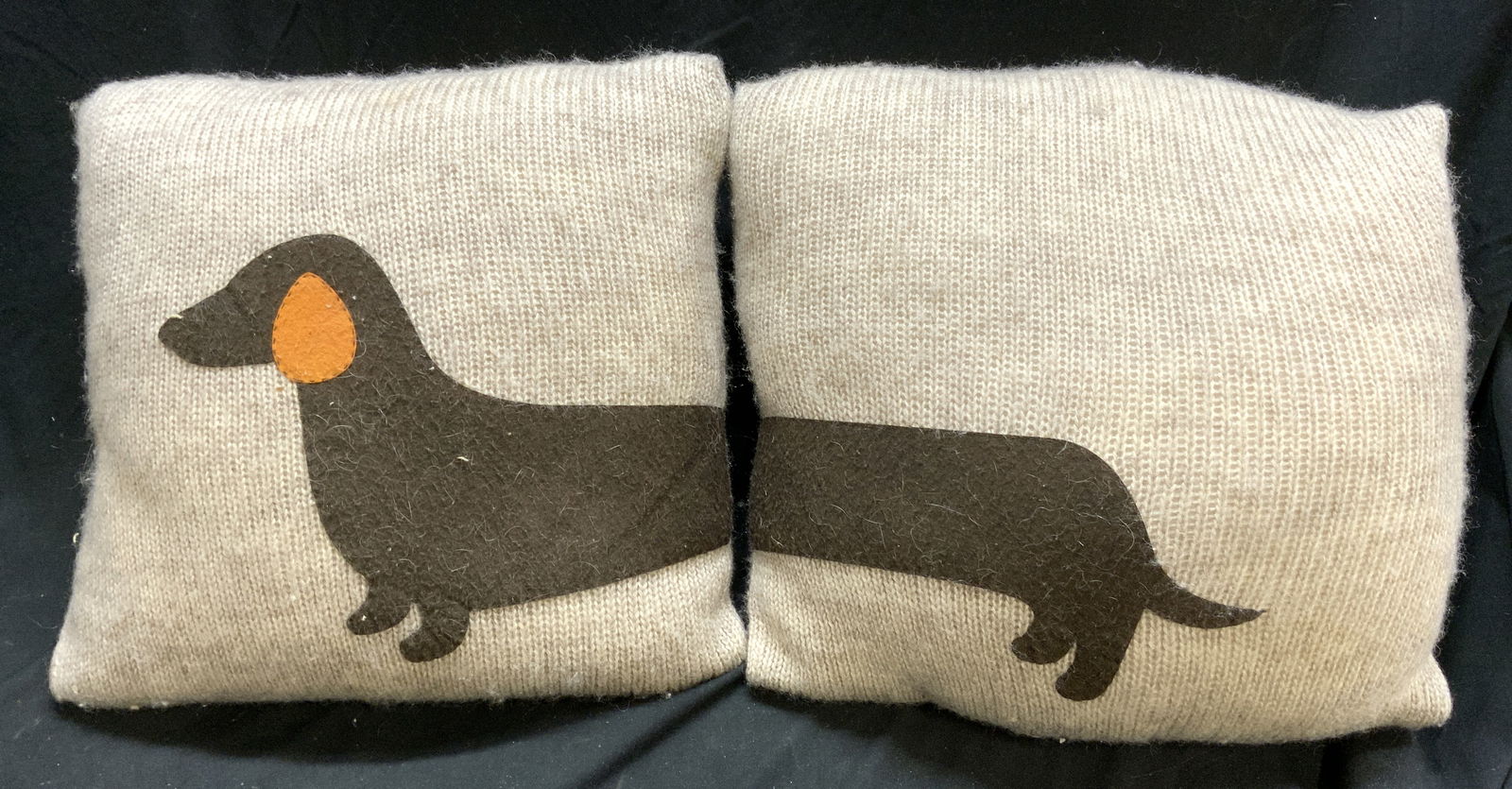 Woven Pillows W Dachshund Patch Detail: Pillows have cream toned woven covers, possibly cashmere. Each pillow has half of a patch brown toned dachshund figure. Each pillow measures approximately 15 inches square 4 inches deep. Pillows, dach