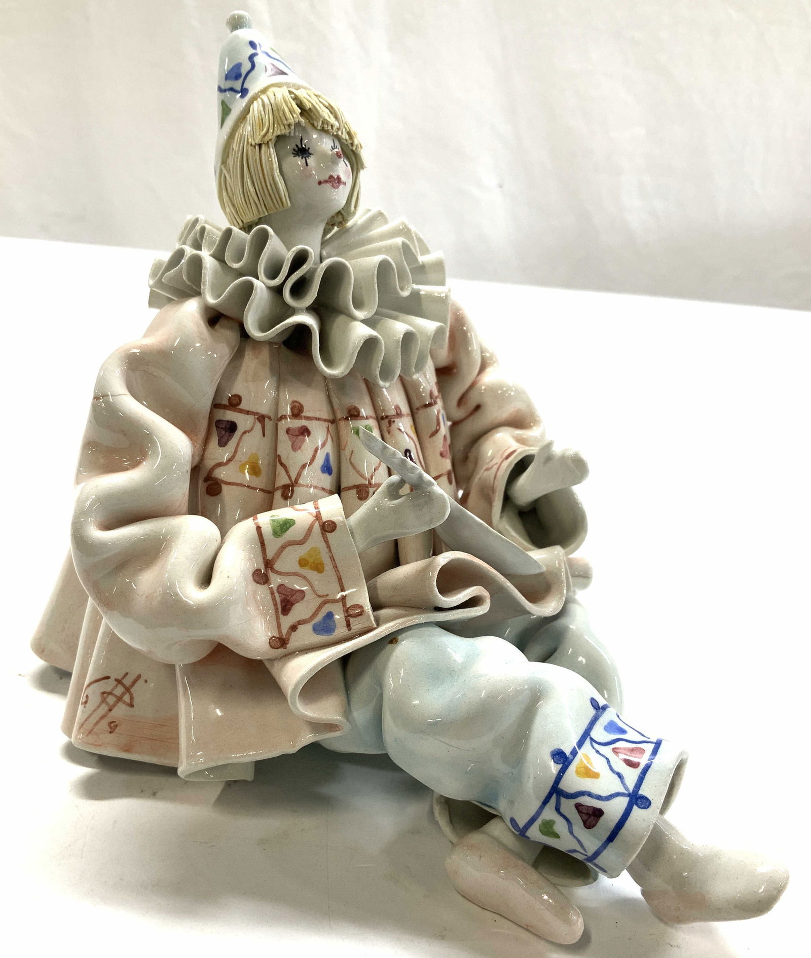 Hand painted Signed Porcelain Clown Figural Italy: Made in Italy, hand painted porcelain clown holding a mandolin, signed illegibly in fold of jacket, ruffled collar, seated position, measures height app 7 inches width app 6 inches, depth 9 inches, cl