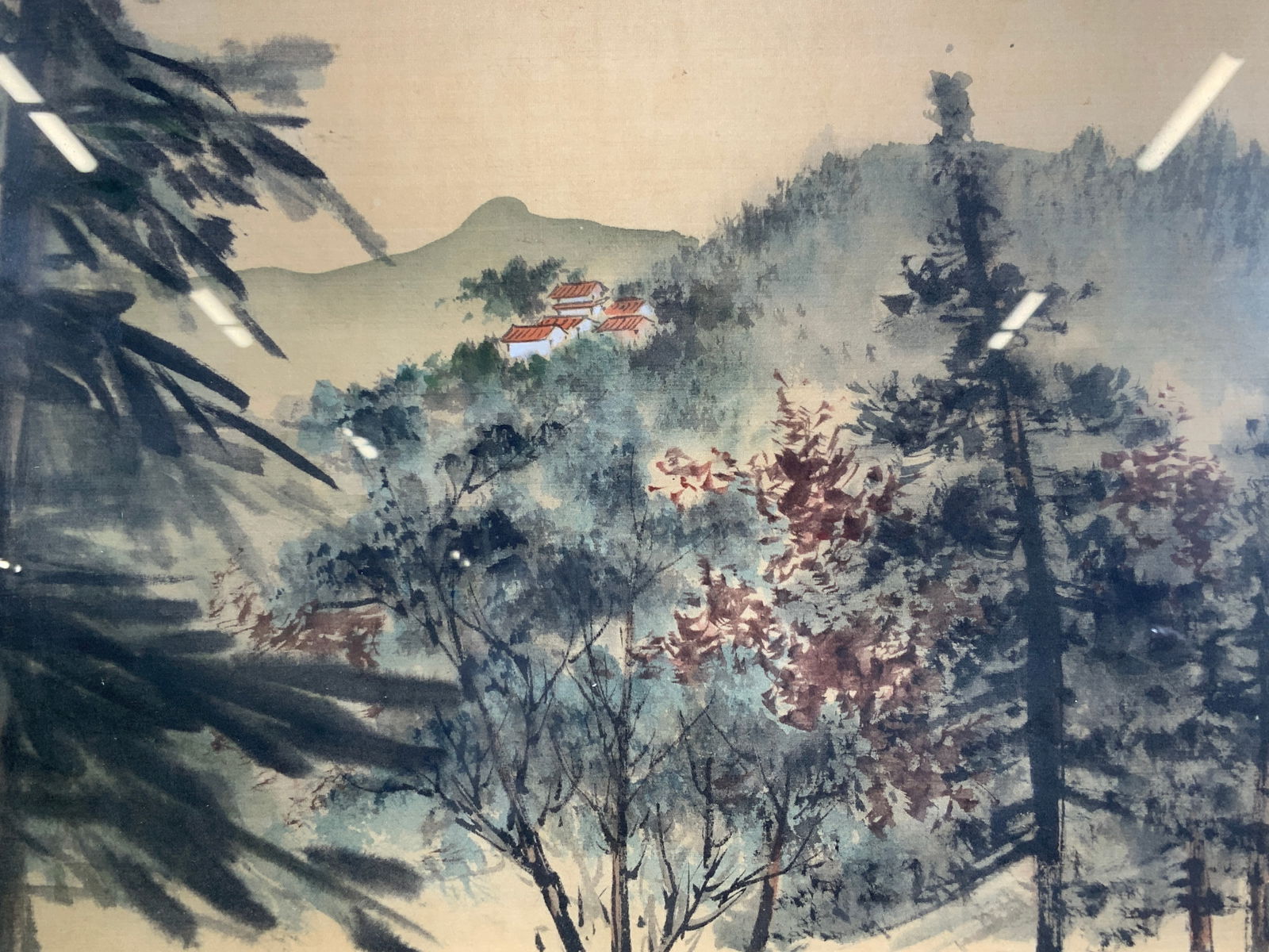 Framed Asian Silk Painting Forest Landscape: Ink and paint on silk. Asian characters and Hanko in lower right corner. Subject depicts a landscape with different trees panning out to the rooftops of buildings. Framed in gilt wooden frame with rai