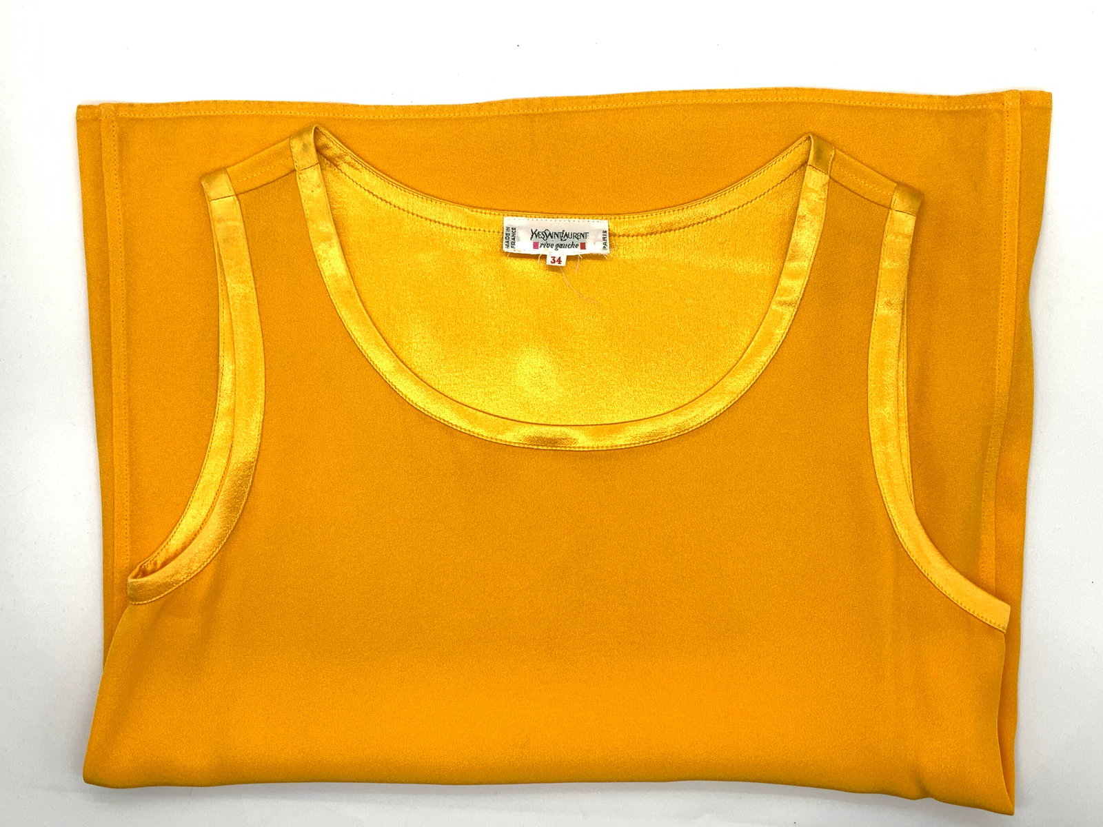 Yves Saint Laurent Tank Top Blouse, France: Vintage Yves Saint Laurent deep yellow- orange dressy tank top. Size 34. Made in France, Original label affixed to garment. Shiny polyester trim. Gently worn. Vintage wear, wearables, tank top blouse,