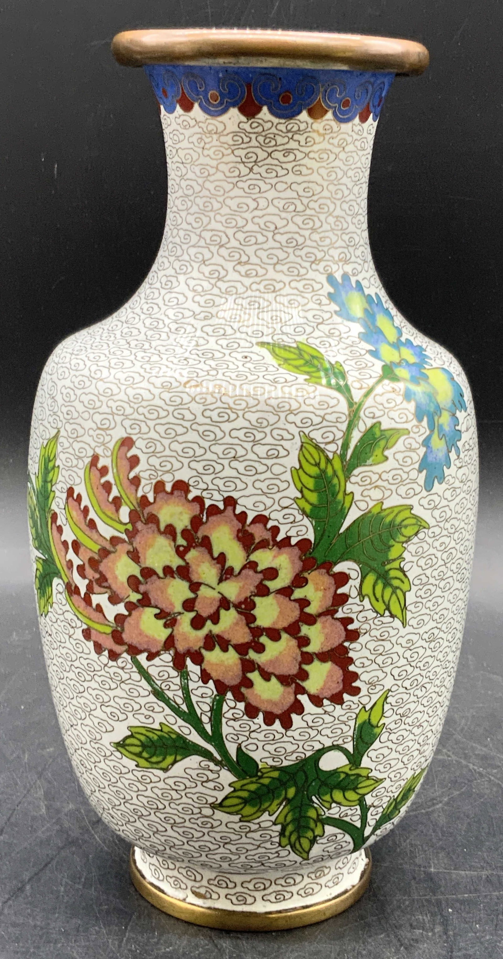 Vintage Asian Cloisonne Floral Motif Vase: A vintage Asian cloisonne floral motif vase. Floral and foliage motif to the obverse. Measures approx. 9H x 4.25W in. Measured at widest point. Pitting present. Some surface wear consistent with age, 