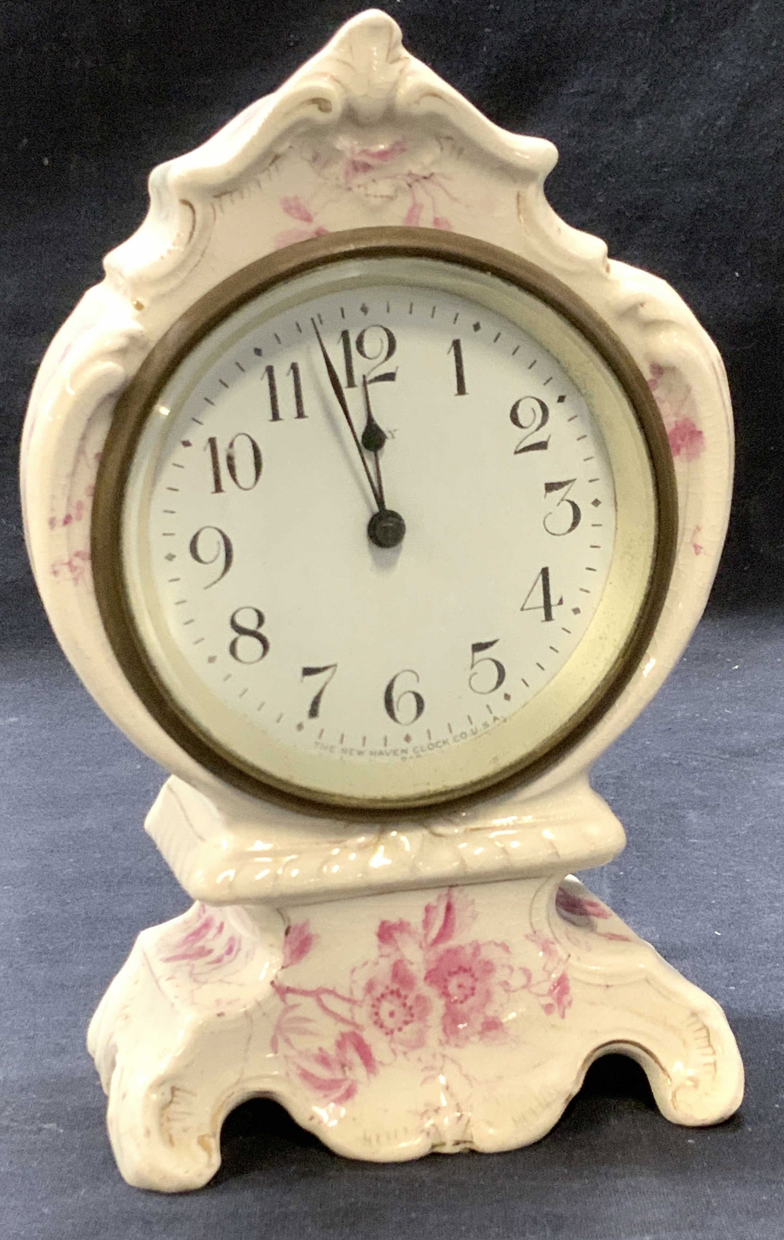Floral Porcelain Clock, New Haven Clock Co, USA: Porcelain hand painted mantle clock . Pink florals on cream background. 8 Day Clock by The New Haven Clock Co. glaze crazing to porcelain. Clock not in working condition. Measures 7.5 in. Ht. x 4.75 i