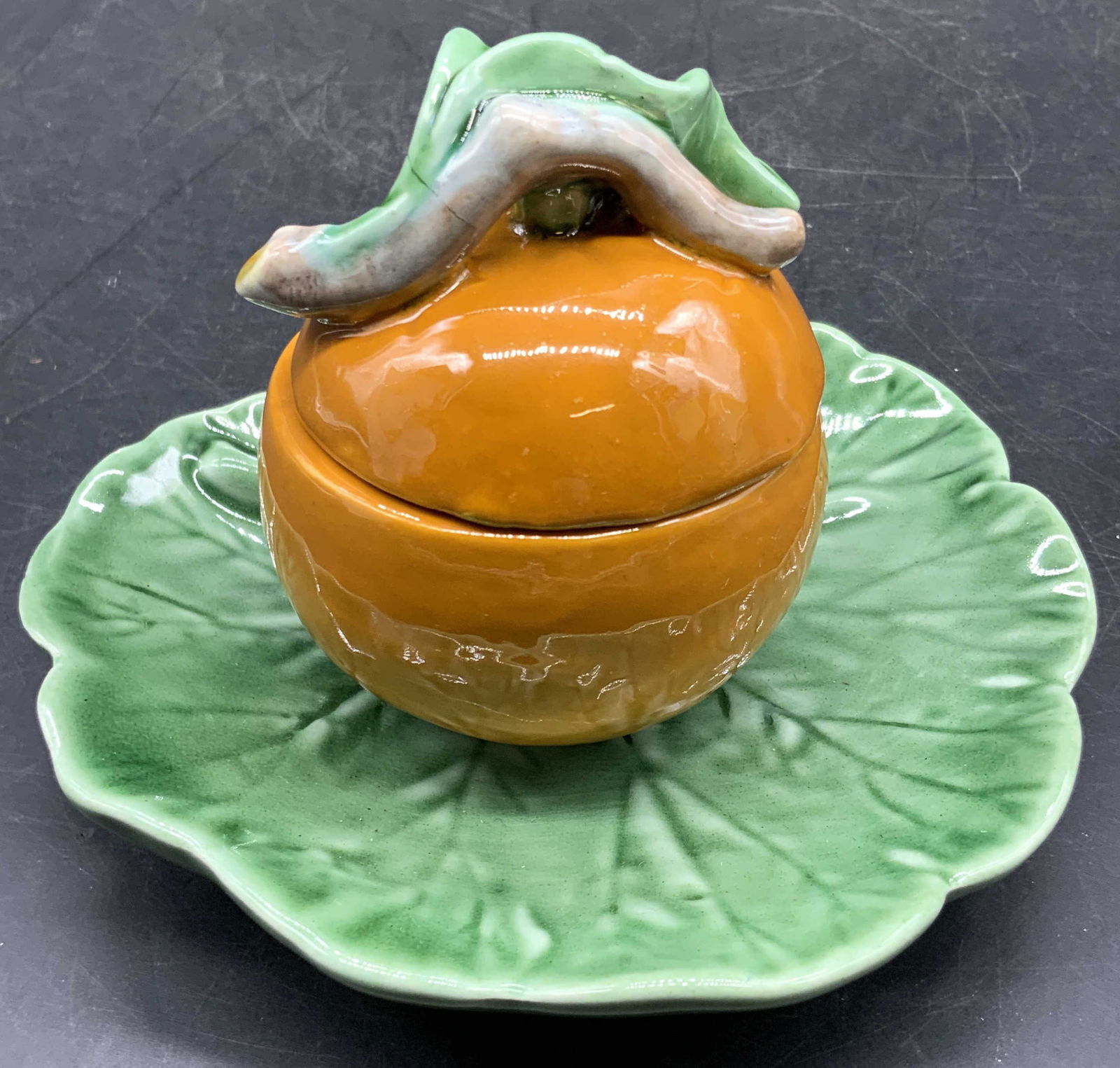 Bordallo Pinheiro Majolica Orange Sugar Bowl, PT: Bordallo Pinheiro Portugal Earthenware Majolica Orange on Green Leaf Jam Holder / sugar bowl. One stamp to the underside is illegible, possibly reads Bordallo Pinheiro. The other markings read MADE IN