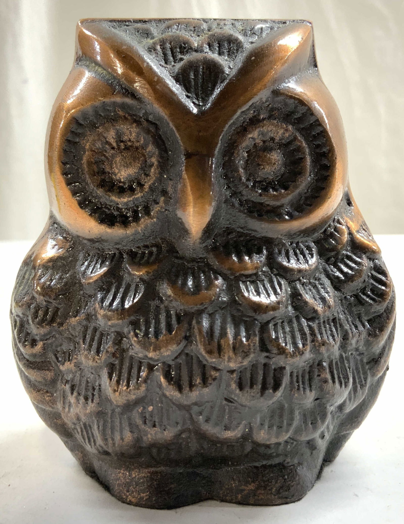 Brushed Metal Copper Toned Owl Figural: Figure is brushed metal. Piece is copper toned. Piece depicts and owl figure. Figure has relief detail to show feather layers and facial detail. Piece measures approximately 4 inches tall 3.25 inches