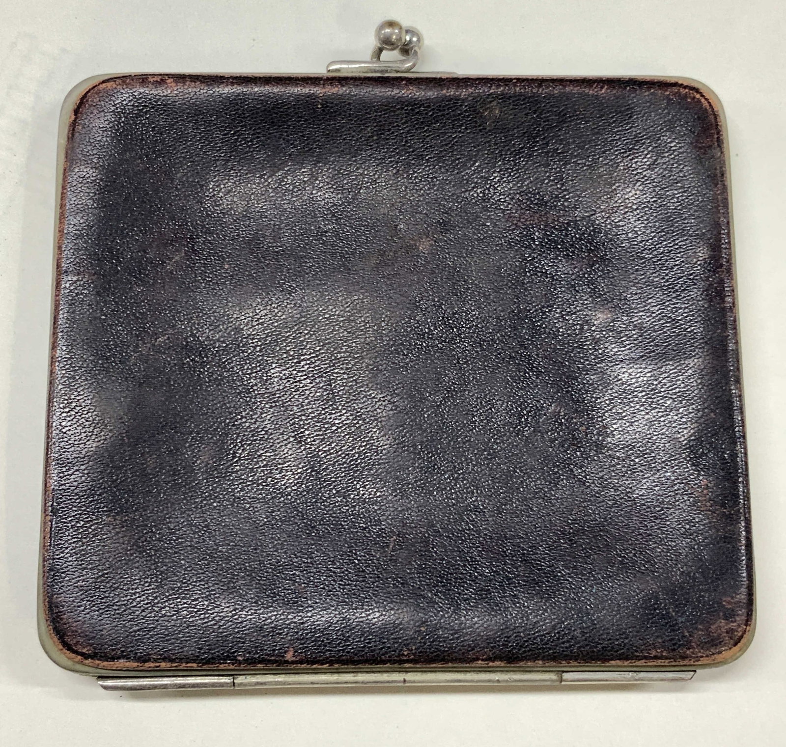 Antq Monpol Cigarettes Leather Case NY: Antique, possibly vintage leather kiss clasp cigarette case. Marked on interior, Monopol Cigarettes. Monopol tobacco works, n.y. Approx 4 x 3.75 inches. Evident wearing to leather on edges and metal f