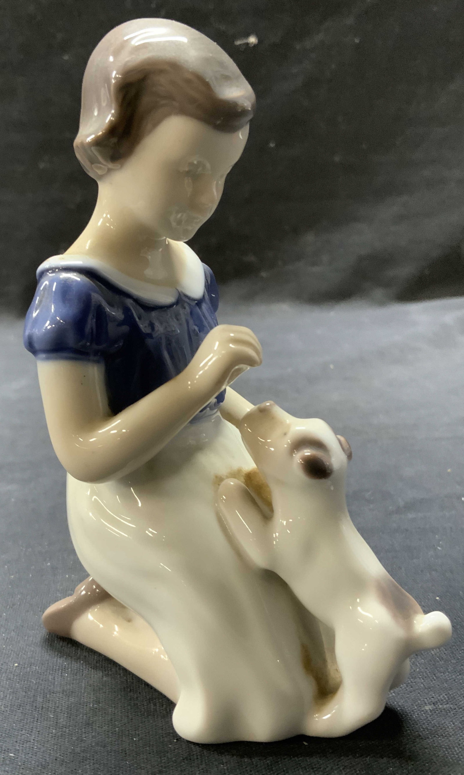 BING & GRONDAHL Girl W Puppy 2316: Underside is marked B&G (Bing & Grondahl). Piece depicts a kneeling girl figure playing with puppy. Measures approx 5 inches tall 4 inches deep 2.5 inches wide. Porcelain figure, Bing and Grondahl gir