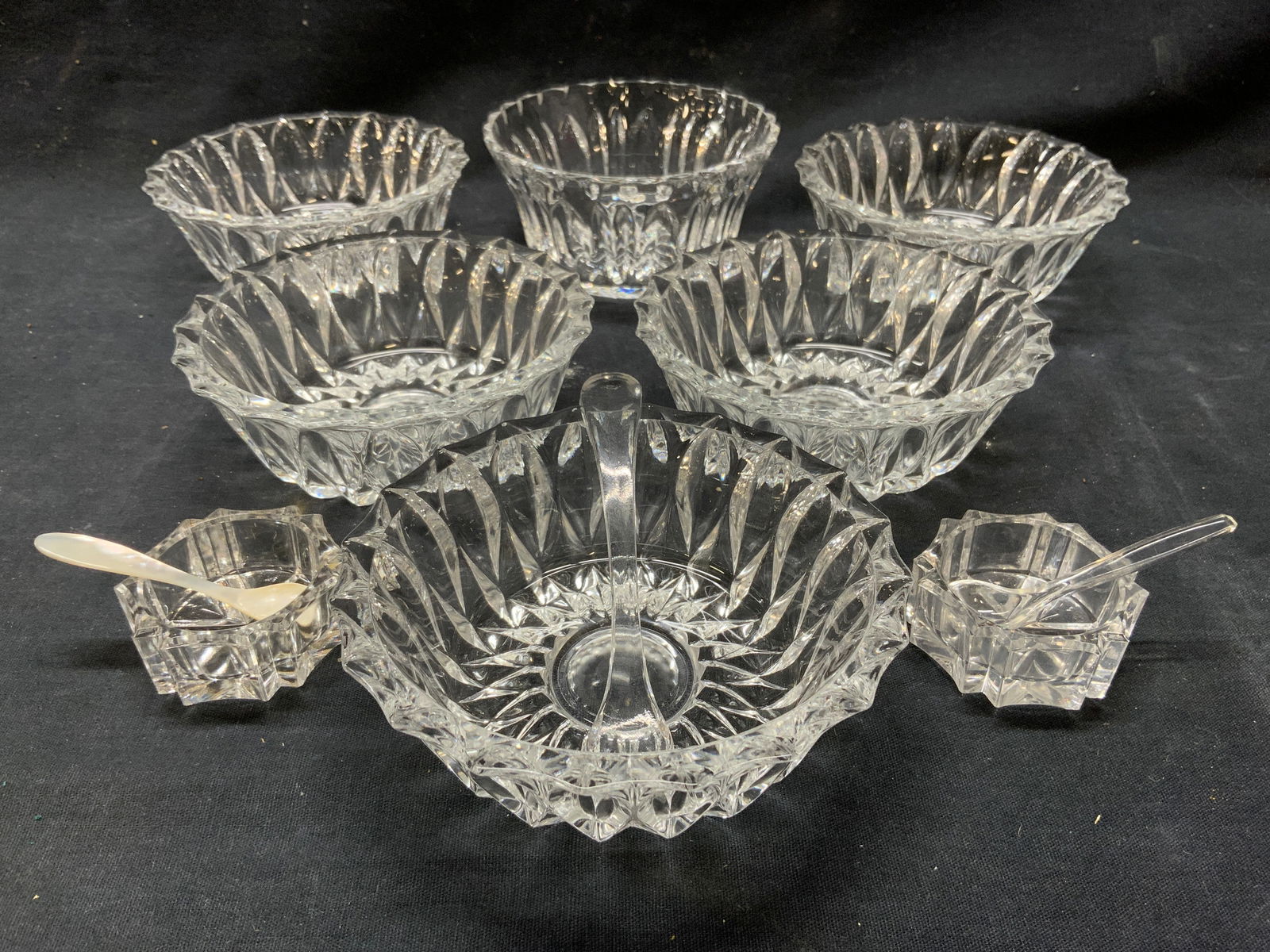 Lot 11 Glass Dessert Bowls Spoons & More: Lot includes 6 glass dessert bowls, 2 glass salt cellars, 1 glass spoon, 1 plastic spoon, & 1 mother of pearl spoon. One bowl differs from other 5. Bowls measure approximately 4.5 inches wide 1.5 inch