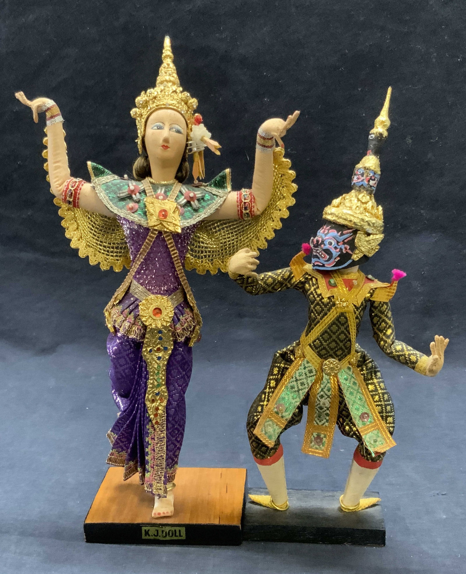 2 Vintage Asian Dancing Doll Figurals, K.J. DOLL +: Two vintage handcrafted Asian dancing doll figurals. The larger piece has a sticker to the base which reads K.J. DOLL. Measures approx. 11.25H x 3.5W in. Multicolored hues and shimmery metallic thread