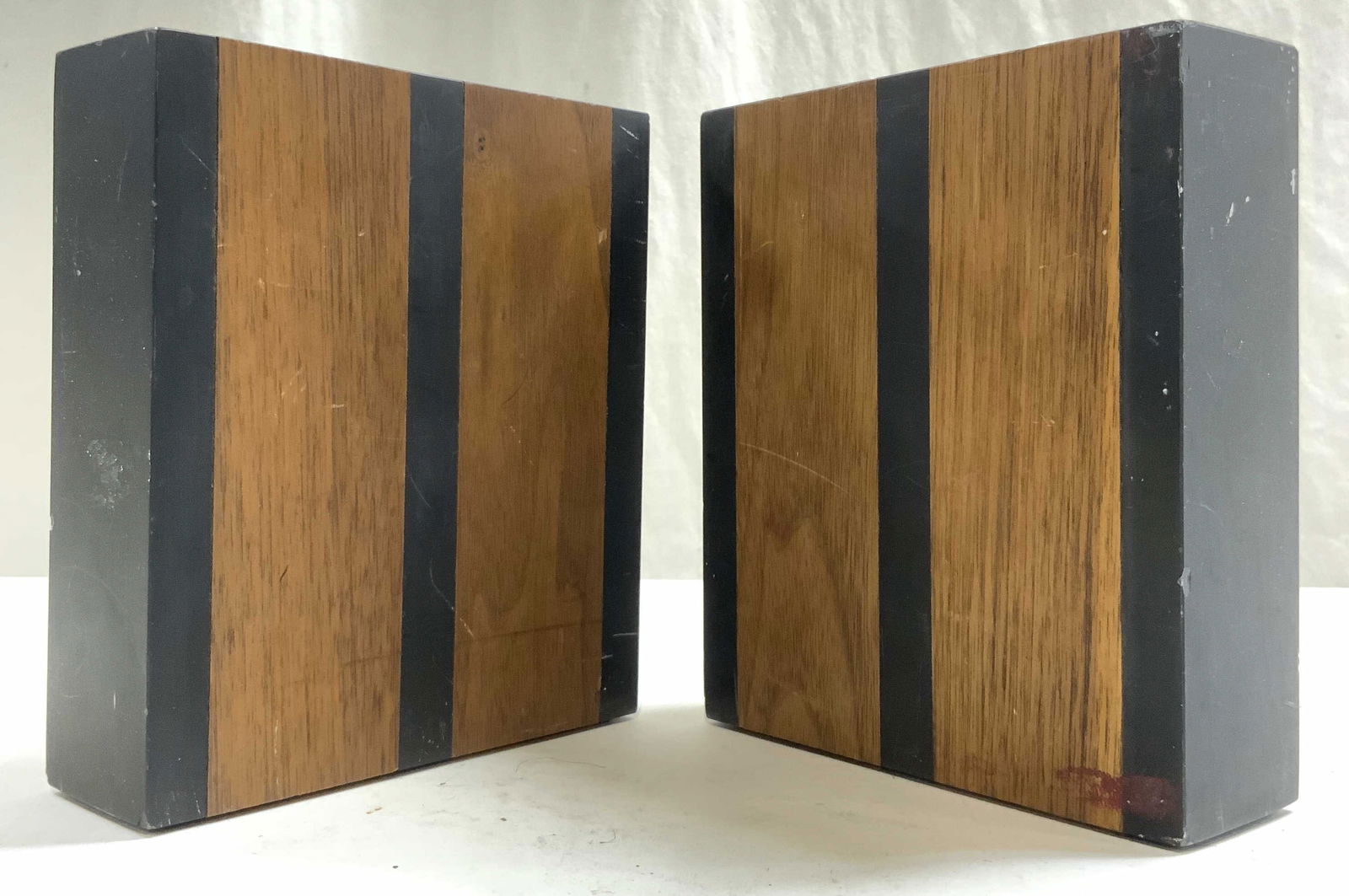 Pair Wood & Slate Bookends: Bookends are wooden and slate. Each piece is brown and black toned. Bookends each have rectangular prism form. Each bookend is 6 inches tall 5.25 inches wide 1.75 inches deep. Bookends, wood and slate