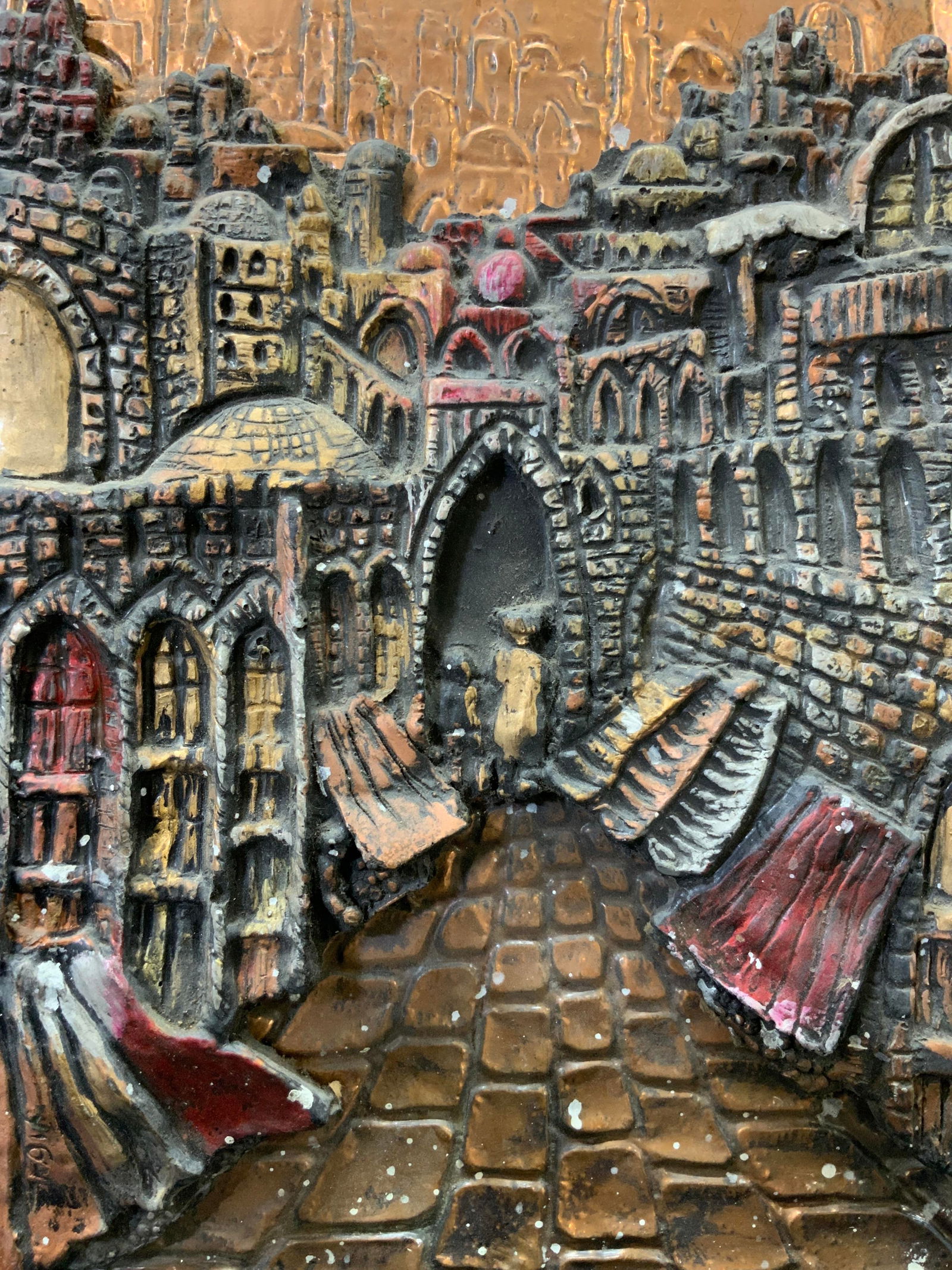 Signed High Relief Copper Embossing Jerusalem: Copper embossing and plaster. Signed on lower left corner. Signature illegible. Subject depicts a street view of Jerusalem with the city in the background. Relief measures approx. 9.25 W x 13 H in. Wh