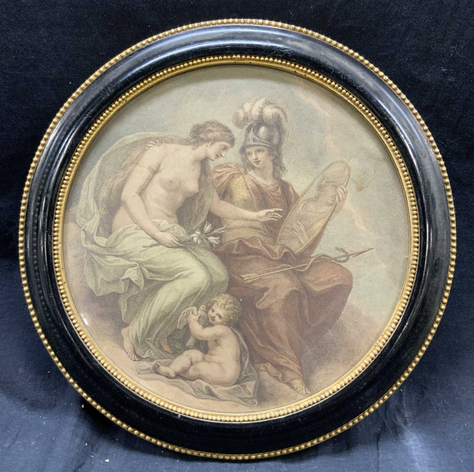 Circular Framed Nude Woman & Soldier Lithograph: Lithograph on paper. Subject depicts a nude female, a soldier holding a mirror and a baby with a dove. Framed in circular gilt wooden frame with dotted gilt borders. Frame measures approx. 13.5 W x 13
