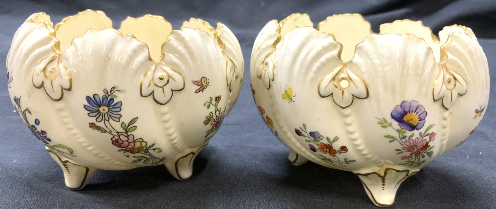 COALPORT Pr Vintage Porc Footed Floral Vessels: Underside is marked COALPORT. Lot includes 2 vessels. Each are white toned & porcelain with multi toned floral & leaf detail. Vessels each have 3 feet. Each piece has gilt rim & measures approximately
