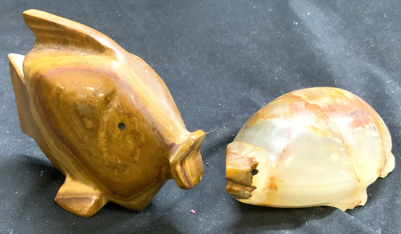 Lot 2 Onyx Fish & Turtle Figurals: Lot includes 1 fish and 1 turtle figure. Each piece appears to be onyx, possibly carved natural stone. Each piece has sienna, beige & white tones. Turtle figure measures approx 7 inches deep 3.5 inche