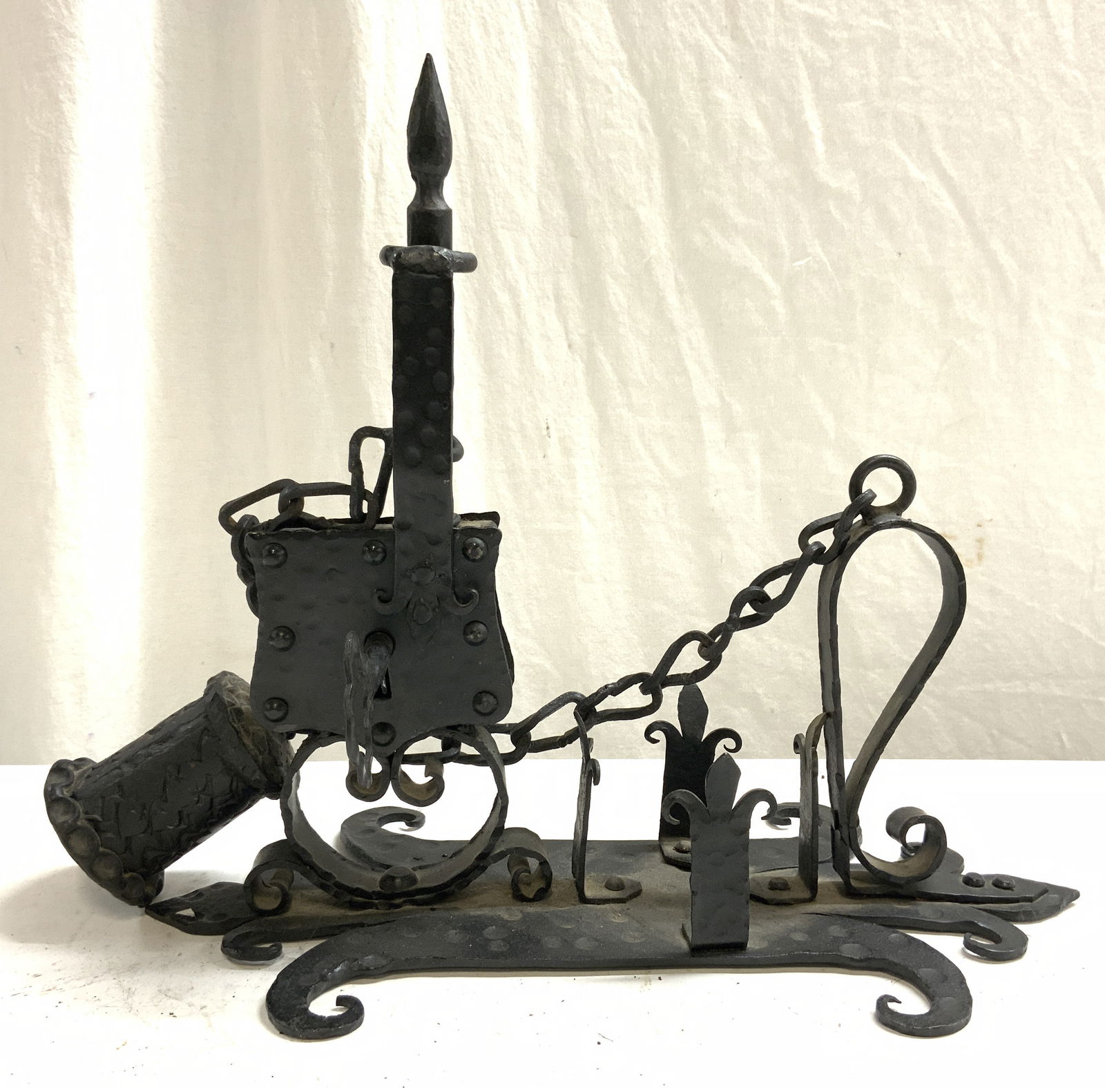 Antique Wrought Iron Wine Bottle Lock: Wine bottle lock is antique. Piece is black toned wrought iron. Lock includes key. Piece measures approximately 14 inches long 12.5 inches tall 8 inches deep. Wine bottle lock, iron wine bottle lock,