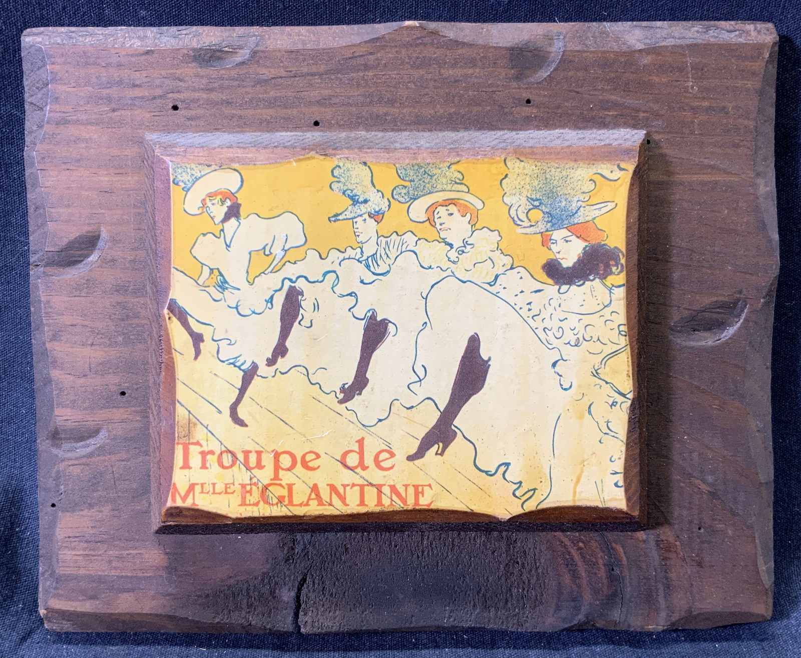 The Troupe Of Mademoiselle Eglantine Lithograph: Lithograph on wood. Original art titled The Troupe Of Mademoiselle Eglantine by Henri de Toulouse-Lautrec. Subject depicts a kick line of dancing girls. Wood measures approx. 7 W x 6 H in. Minor wear