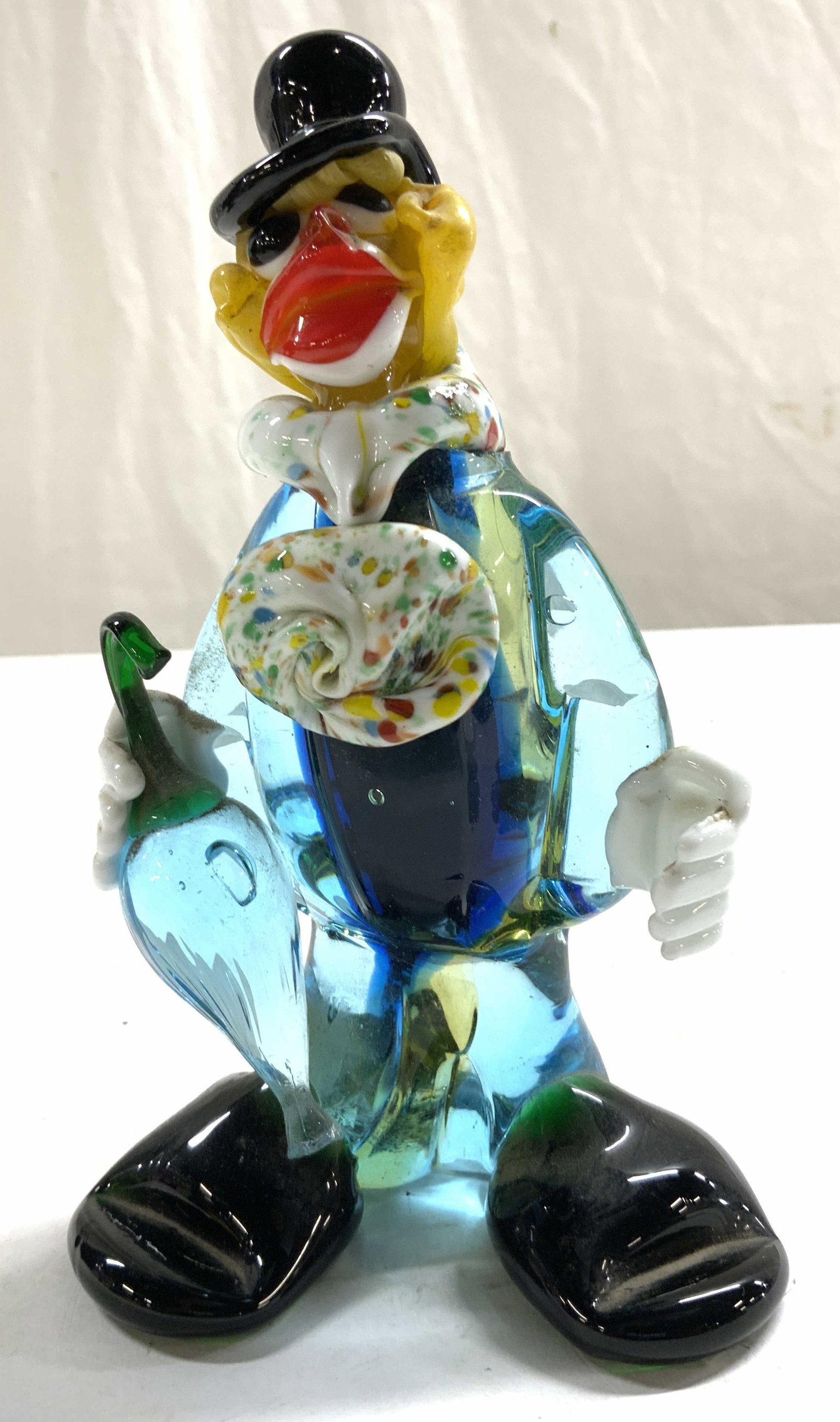 MURANO Glass Art Glass Clown Figural: Figure appears to be MURANO glass. Piece depicts a clown figure with umbrella, top hat, and multi toned detail. Some elements appear to be hand blown. Piece Measures approx 6 inches tall 3.75 inches w