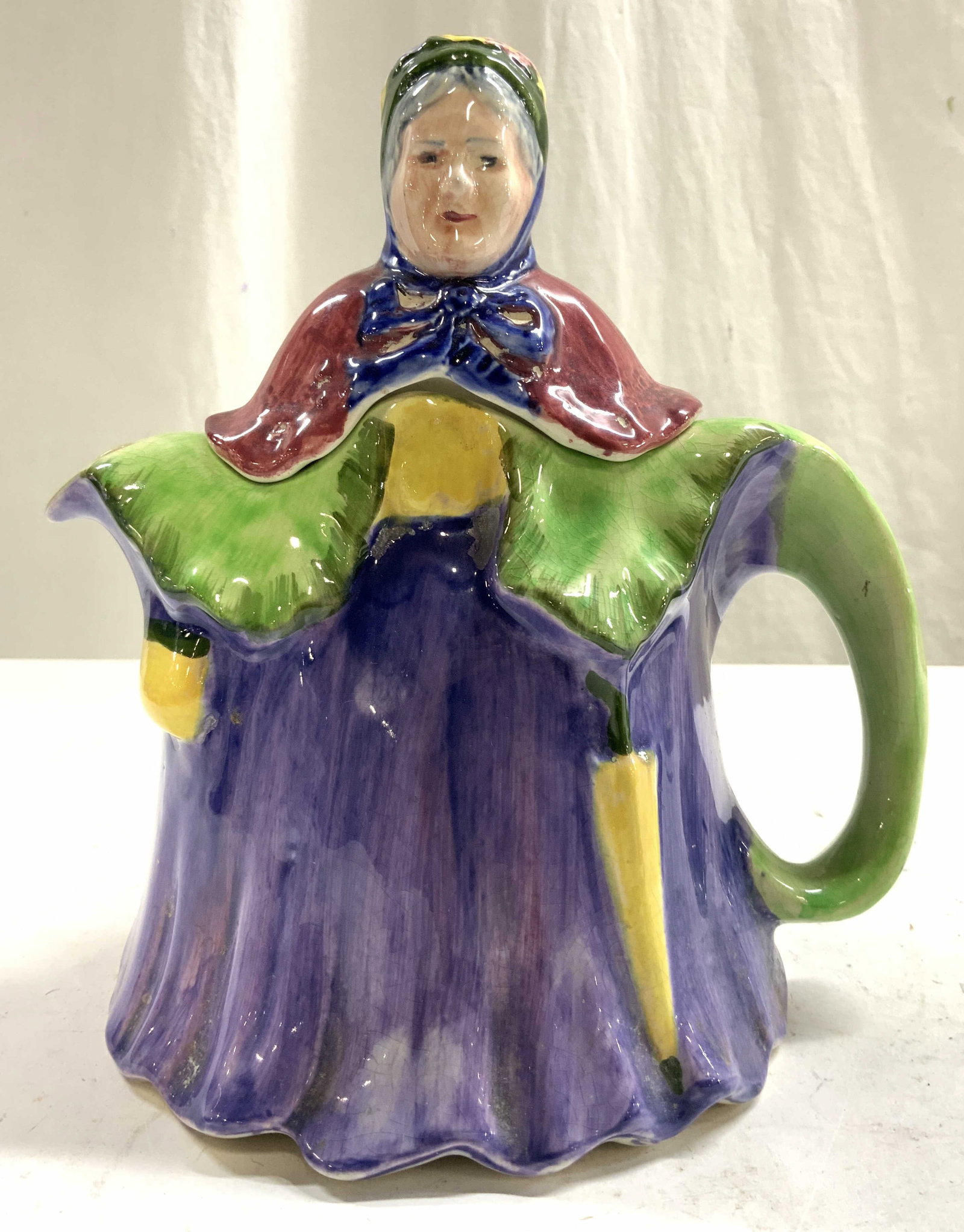 Vntg English Ceramic Elderly Woman Teapot W Lid: Teapot is ceramic, piece appears to be hand painted. Teapot is in the form of an elderly female figure wearing large gown and hat. Teapot appears to be vintage. Teapot measures approximately 8.5 inche