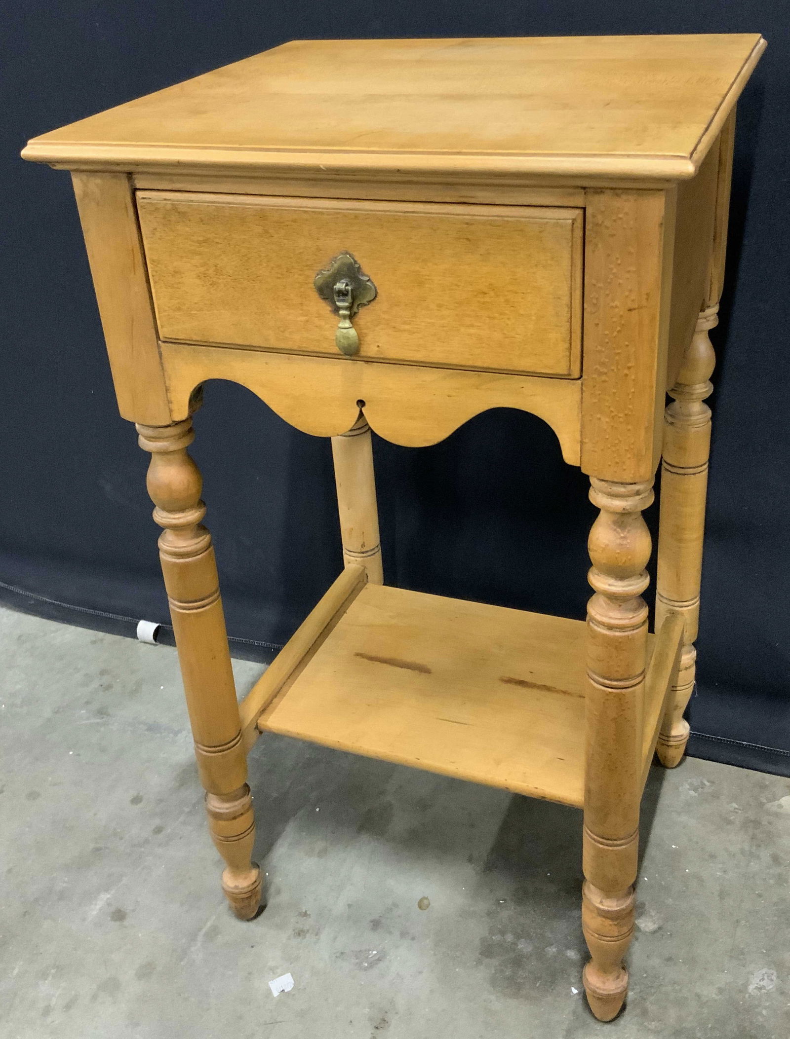 Vintage Traditional Wooden Side Table W/ Drawer: A vintage traditional side table with a drawer to the obverse. Crafted from wood. Metal hardware to the drawer. Measures approx. 28H x 15D x 16W in. Some wobble to the piece. Surface wear consistent w
