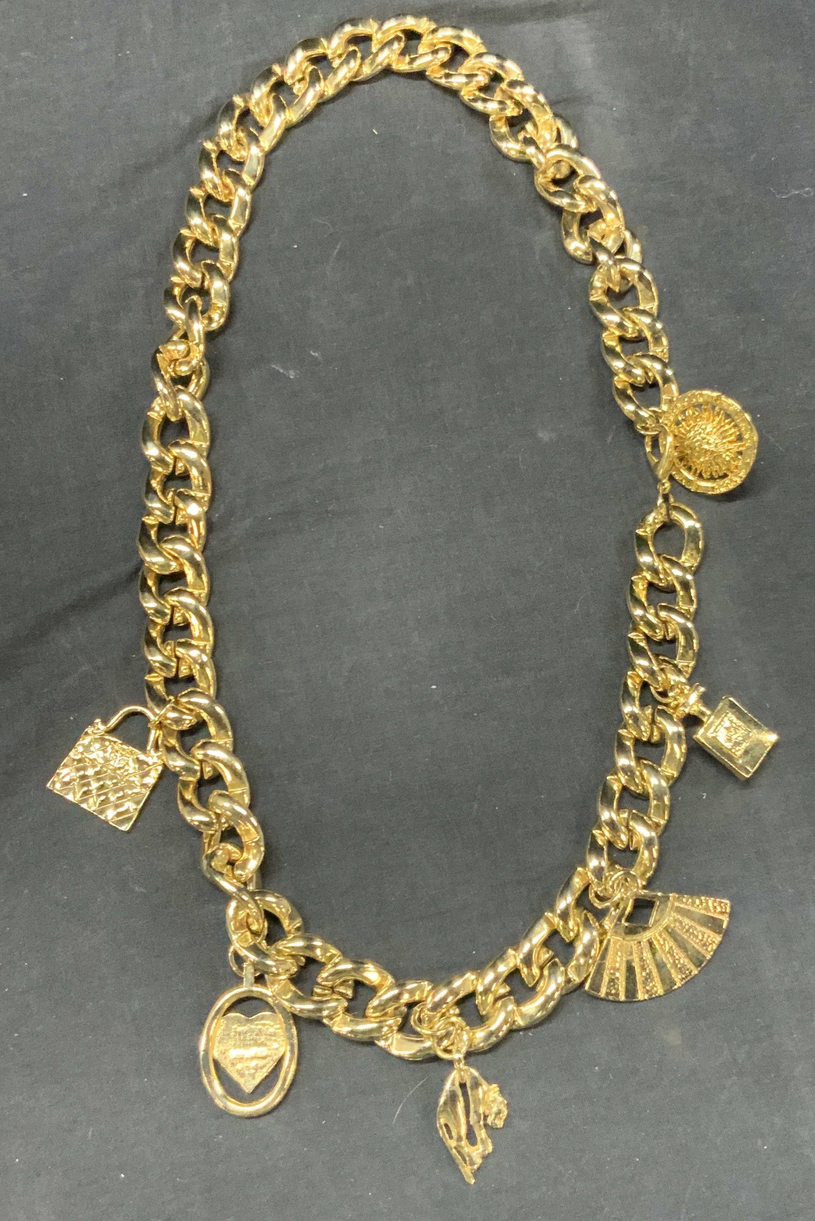 Vntg Gold Tn Charm Body Chain Accessory: Vintage gold tone body chain with various charms, a purse, perfume bottle, fan, heart, wild cat and a sun with pairs, Rome. New York and Tokyo on it. Approx 14 inches long total length being 34 inches