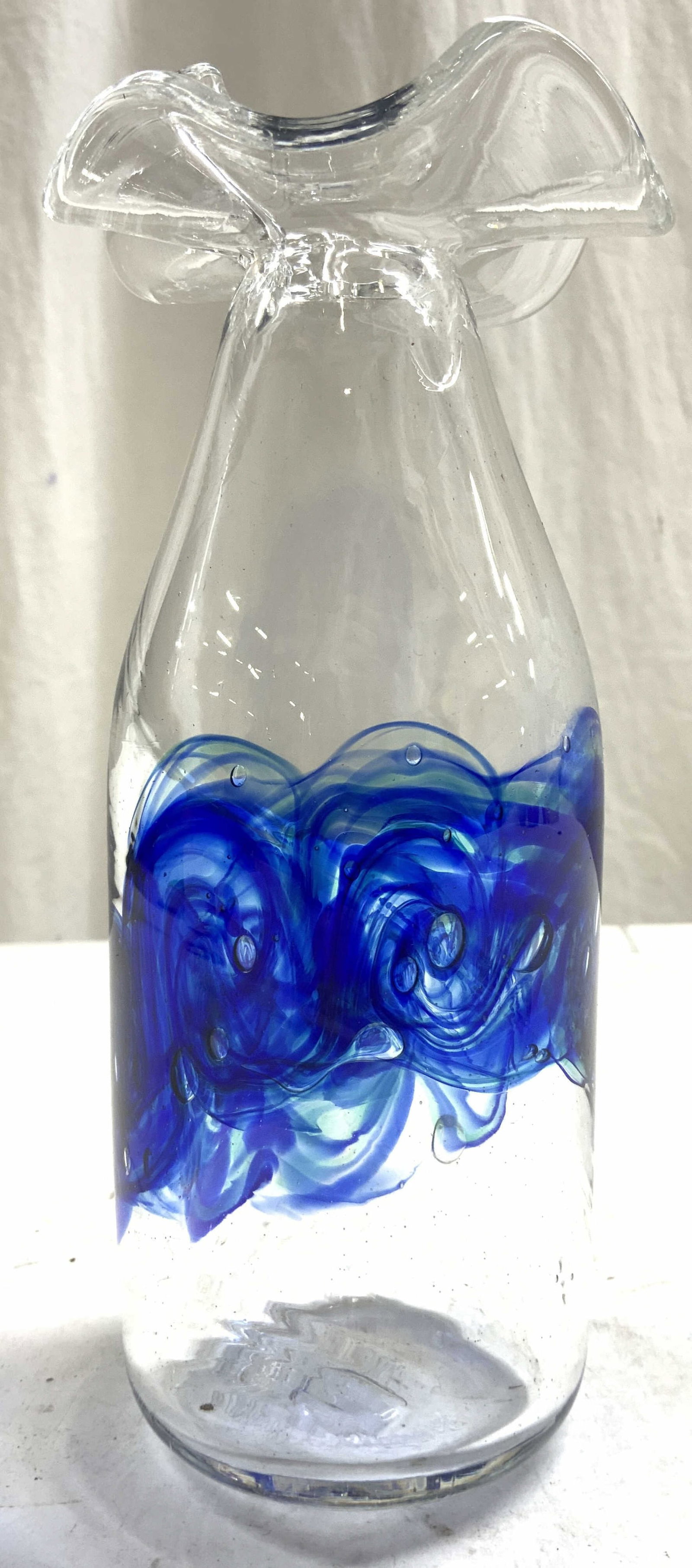 Hand Blow Art Glass Vase Vessel: Underside is inscribed MERRY CHRISTMAS. Vase is hand blown glass. Piece has blue toned swirl derail throughout mid piece. Top of vase has handkerchief style form. Piece measures approximately 7.75 inc