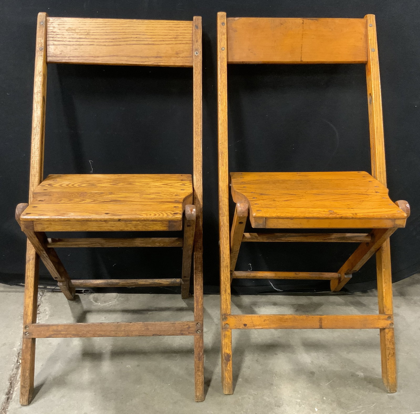 Pair Vintage Wooden Collapsible Chairs: A pair of vintage wooden collapsible chairs. Open the pieces measure approx. 31H x 14W x 13D in. Width and depth taken at seat. Scratching, chipping, and surface wear present. Vintage furniture, vinta