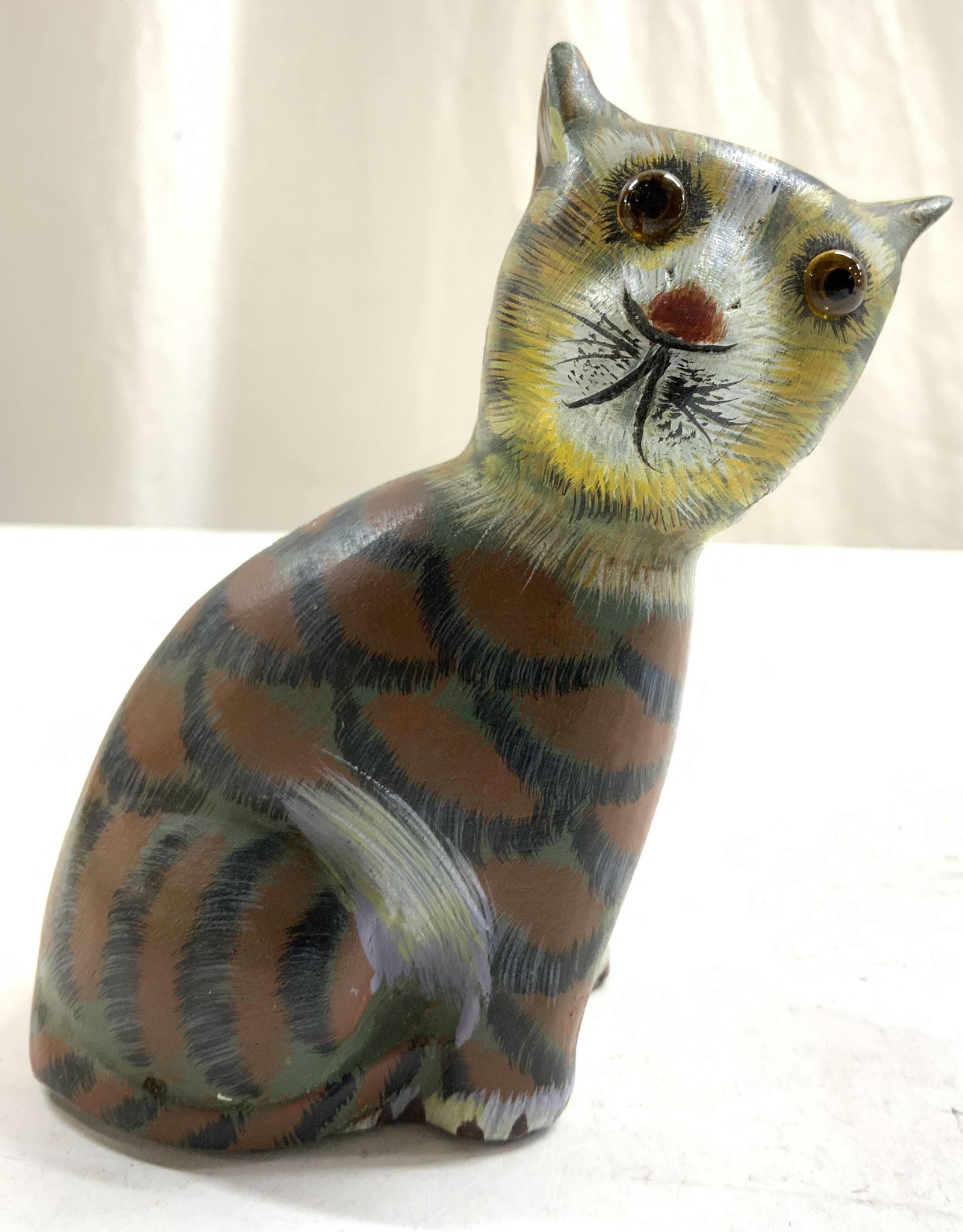 Hand Painted Plaster Seated Cat Figure: Cat figure appears to be plaster. Piece is hand painted with multi toned detail. Depicts a seated cat figure looking to its side. Cat figure measures approximately 4.75 inches tall 4 inches deep 2.5 i