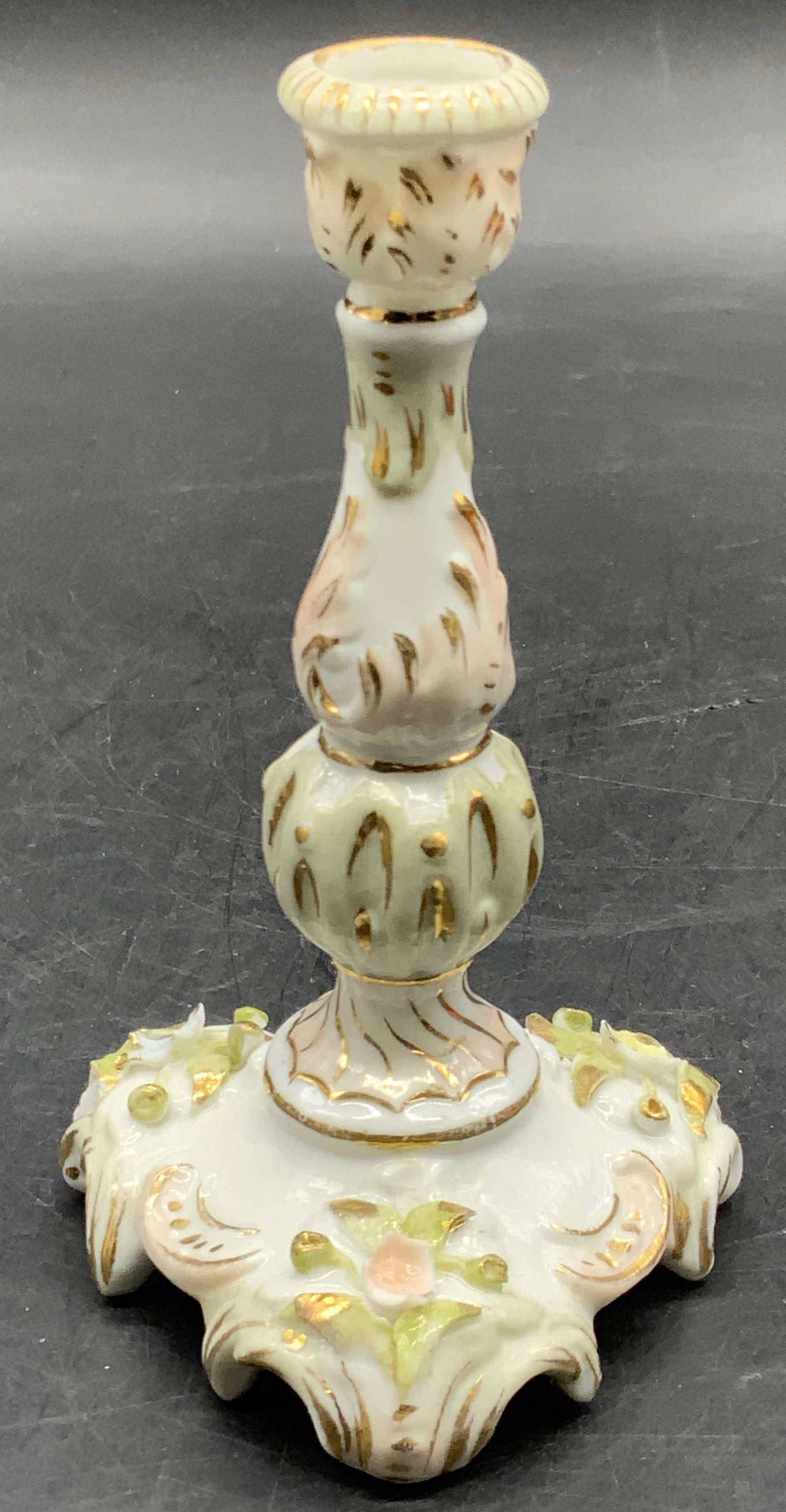 Vintage Hand Painted Porcelain Candlestick: A vintage hand painted porcelain candlestick. Gilt accents and floral motifs. Measures approx. 4.75H x 2.75W in. Pitting to the piece. Chipping present. Collectibles, Porcelainware, ceramicware, Vinta