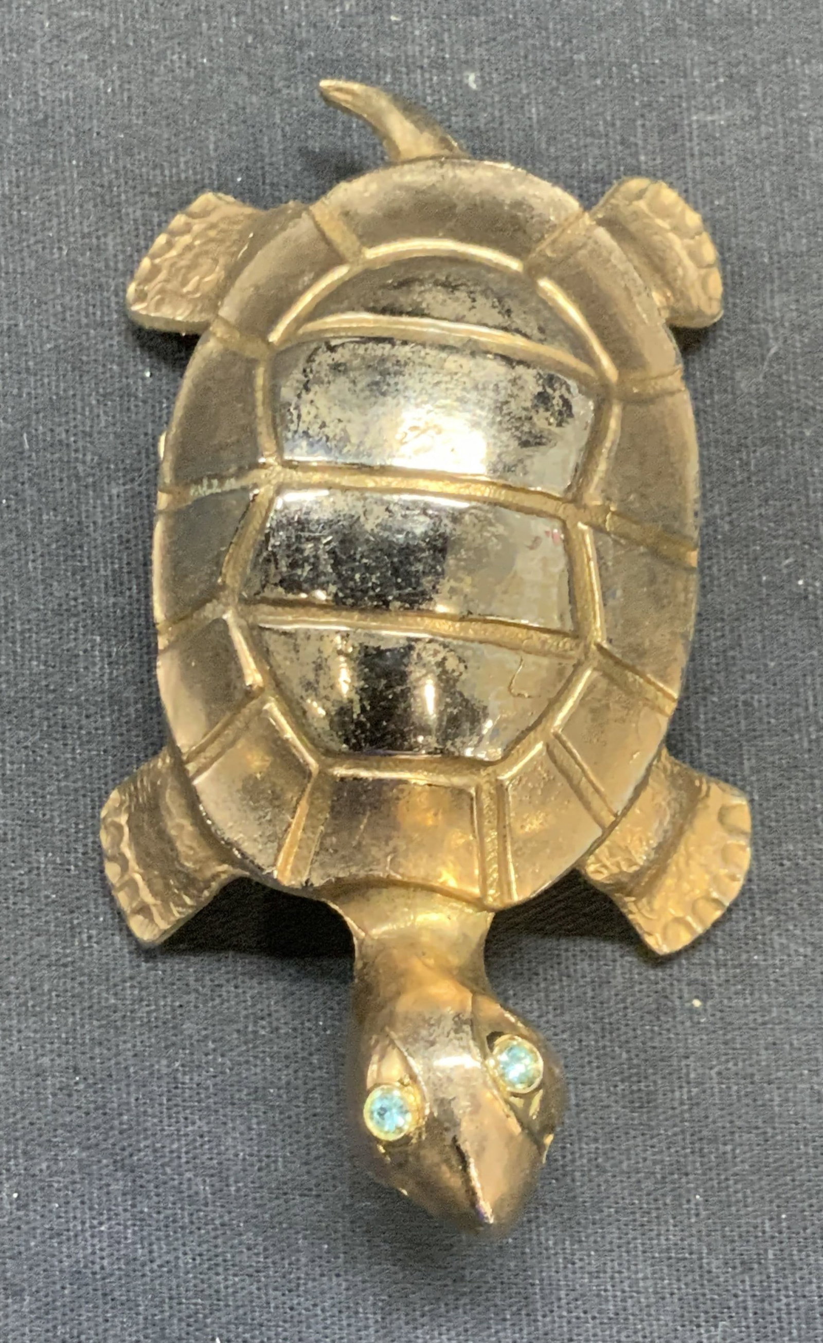 Gold Tone Turtle Figural Clip: Gold tone turtle Figural clip with green crystal eye detail. Measures approx. 3.75 x 2 x 1 inches. Some surface wear including scratching observed. Turtle, gold tone turtle, turtle Figural, turtle cli