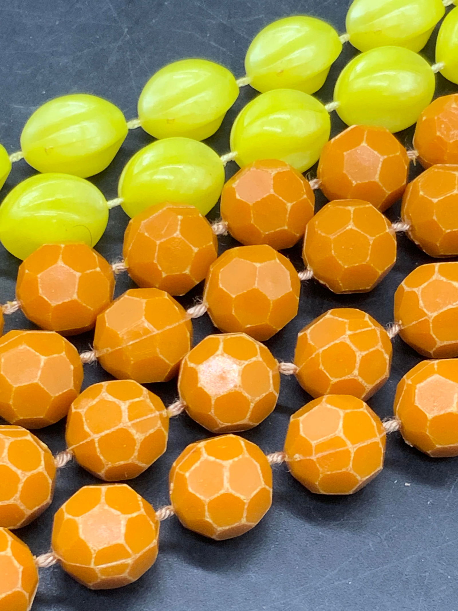 Lot 2 Orange & Yellow Beaded Necklaces, Jewelry: Two composite beaded necklaces. One necklace features faceted orange beads and the other features yellow beads. Both pieces secure with C Spring clasp closures. Orange necklaces measures 55 inches in