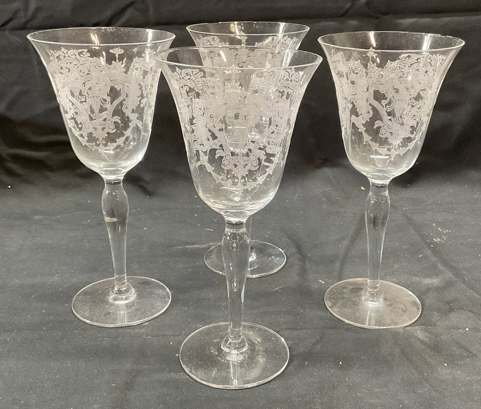 Set 4 Etched Scroll Wine Glasses: Set of 4 wine glasses with etched scroll motif. Measure approx. 3.5 x 7.75 inches each. Some surface wear to all pieces, small chips to rims of all pieces. Wine glass, etched wine glass, Barware, bar 