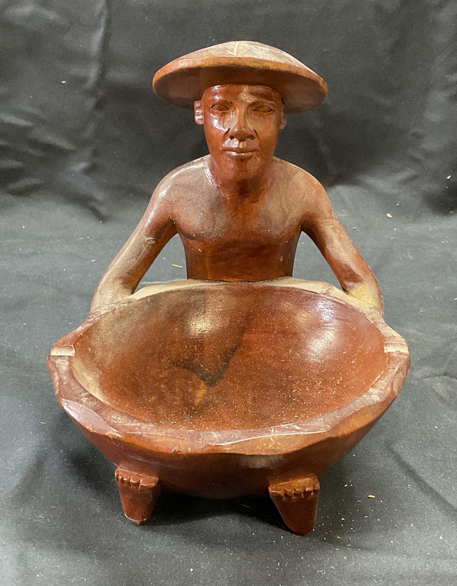 Vintage Asian Hand Carved Wood Figural Bowl: Vintage hand carved wood bowl/ashtray. Figure of Asian man. Measures approx. 6.5 x 6 x 7 inches. Some surface wear including scratching observed. Asian bowl, Asian ashtray, figural bowl, figural ashtr