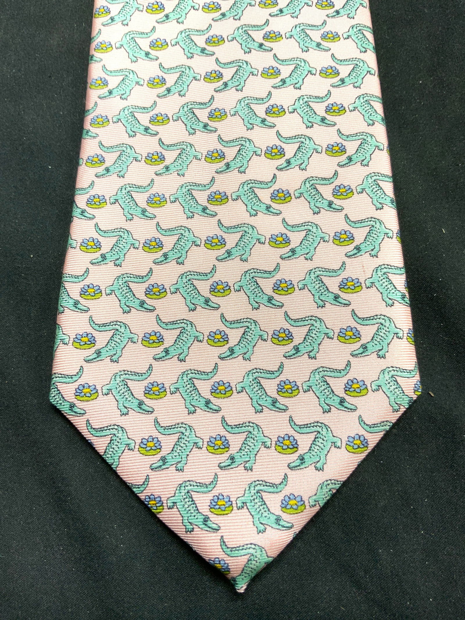 PETER BLAIR Italian Silk Alligator Detail Necktie: Tag reads PETER BLAIR. Piece is pink with green toned alligator and floral pattern detail. Other tag reads ITALIAN SILK. Neckties measures approximately 58 inches long 3.5 inches wide. Tie, neckties,