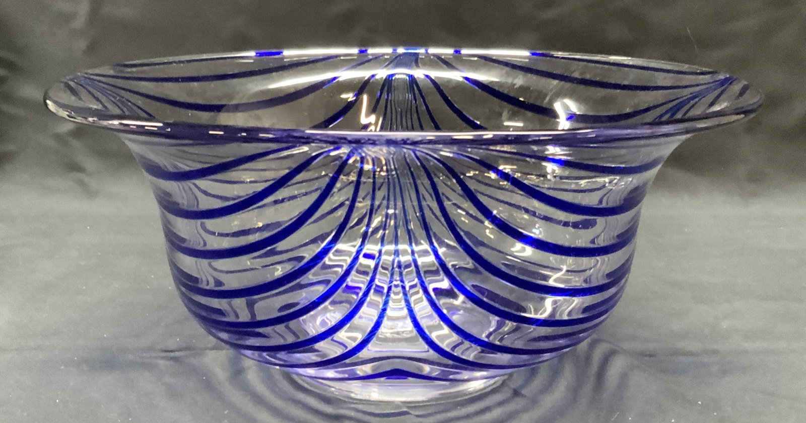 Hand Blown Blue Stripe Art Glass Bowl: Hand blown blue pulled stripe Art glass bowl. Marked M to underside. Measures approx. 10 x 4.5 inches. Some surface wear including scratching observed. Art glass, art glass bowl, blue bowl, striped bo