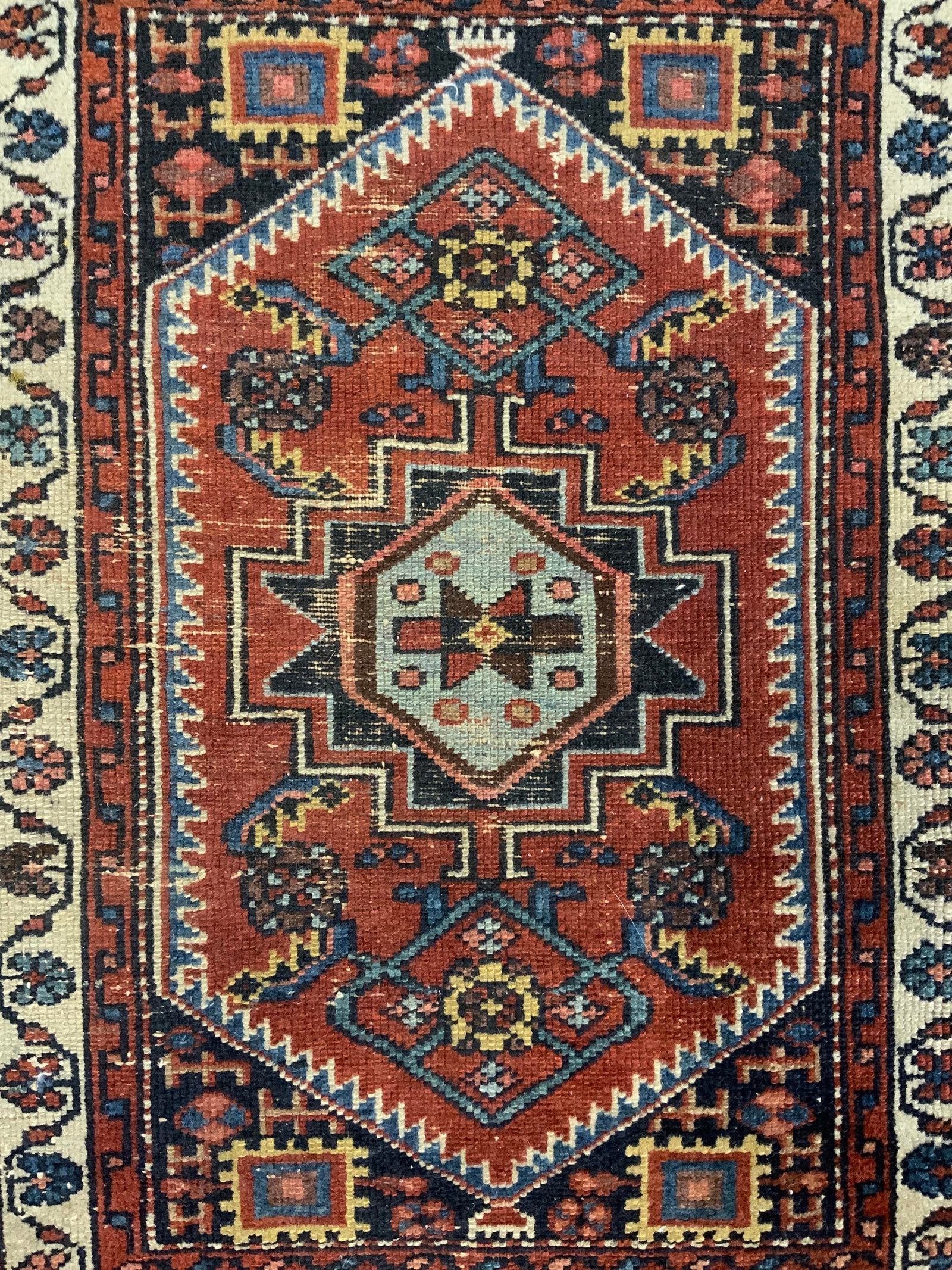 Vintage Handmade Persian Wool Area Rug: Rug is handmade and wool. Piece has intricate multi toned floral motif & geometric derail. Rug is vintage. Piece measures approximately 29 inches long 23 inches wide Rug, carpet, wool rug, Persian rug