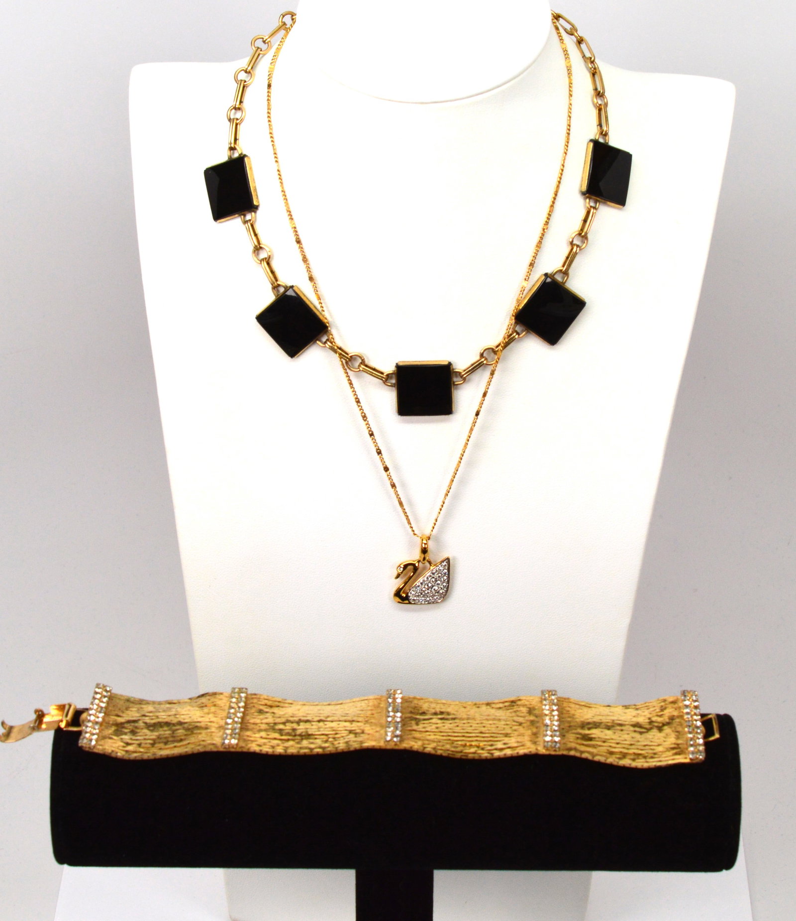 Lot3 Jewelry, Swarovski Gold Plate, WRF & more: Swarovski GP Necklace w Crystal Swan, Bracelet w Crystal Bars, Vintage WRF Necklace w Onyx16IN gold plated necklace holds a trademark Swarovski swan charm adorned with Swarovski crystals. A 7IN long, 
