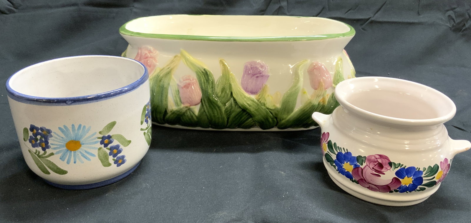 Lot 3 Trademarked Ceramic Planters: Lot includes 3 planters. Each appear to be ceramic. Two of the 3 are trademarked. One marked BAGI ANDRE JASZAROKSZALLAS, & 1 marked for HUNGARY. Each planter has multi toned floral and leaf detail. In
