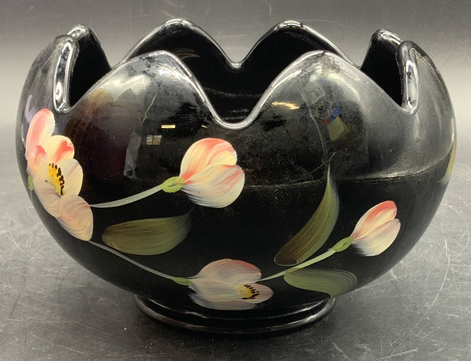 FENTON USA Sig Hand Painted Midnight Garden Vase: Fenton USA Midnight Garden vase. A black glass vase with a hand painted floral motif to the sides. Sticker to the side reads FENTON, HANDPAINTED IN USA. Underside signed HAND PAINTED BY A. RUSSELL. Un