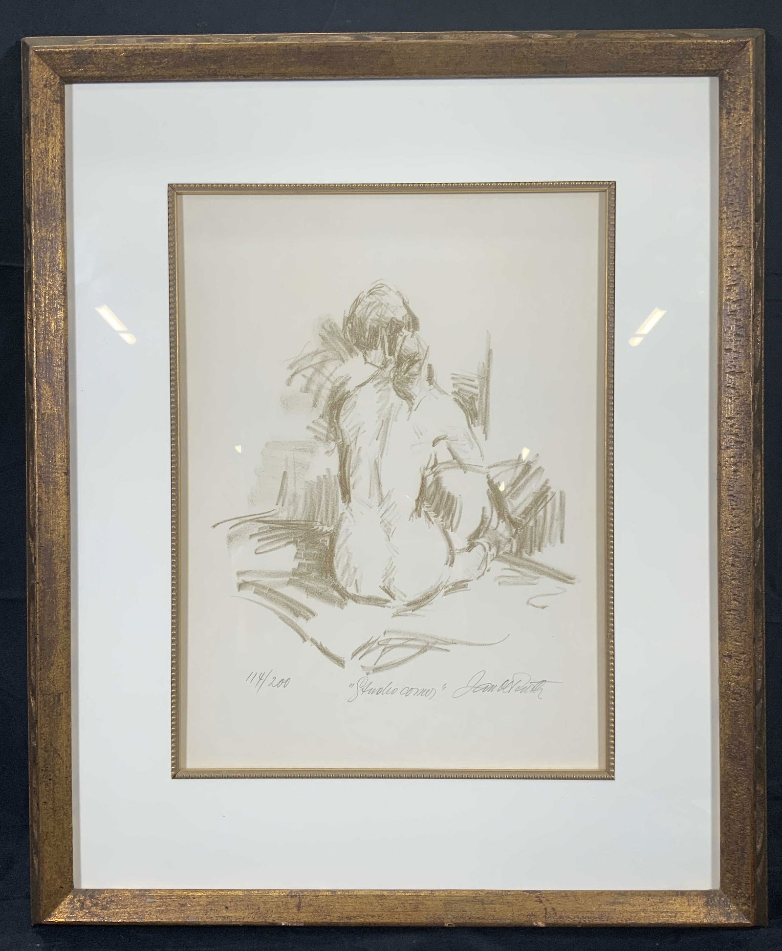 Jan De Ruth Studio Corner Nude Framed Lithograph: Lithograph on paper. Titled Studio Corner. Signed in lower right corner. Limited edition number 114/200. Subject depicts a nude woman sitting, facing a corner. Framed in gilt wooden frame with carved