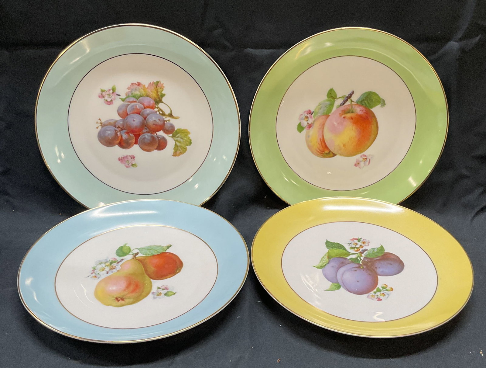 Set4 Vntg TIRSCHENREUTH Porcelain Fruit Plates Germ: Set of 4 vintage TIRSCHENREUTH porcelain plates. Blue, green, and yellow borders with gilt rims and fruit motifs. Trademarked to undersides. Marked US Zone. Made in Germany. Measure approx. 8.25 inche