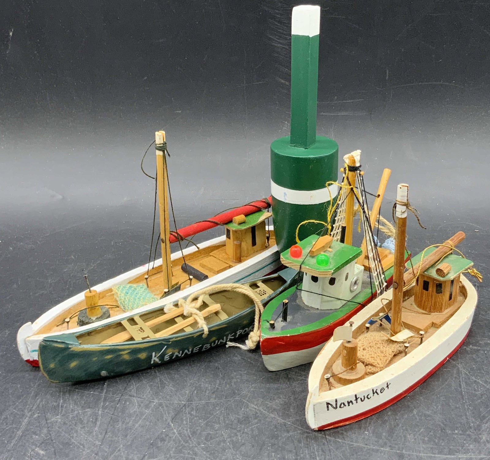 Lot 5 Nautical Wooden Boat & Buoy Figurals: Five wooden boat and buoy figurals. Pieces are crafted from wood, fabric, metal, and plastic materials. Buoy figural measures approx. 6H x 1.5W in. Some pieces have writing to the sides which read NAN