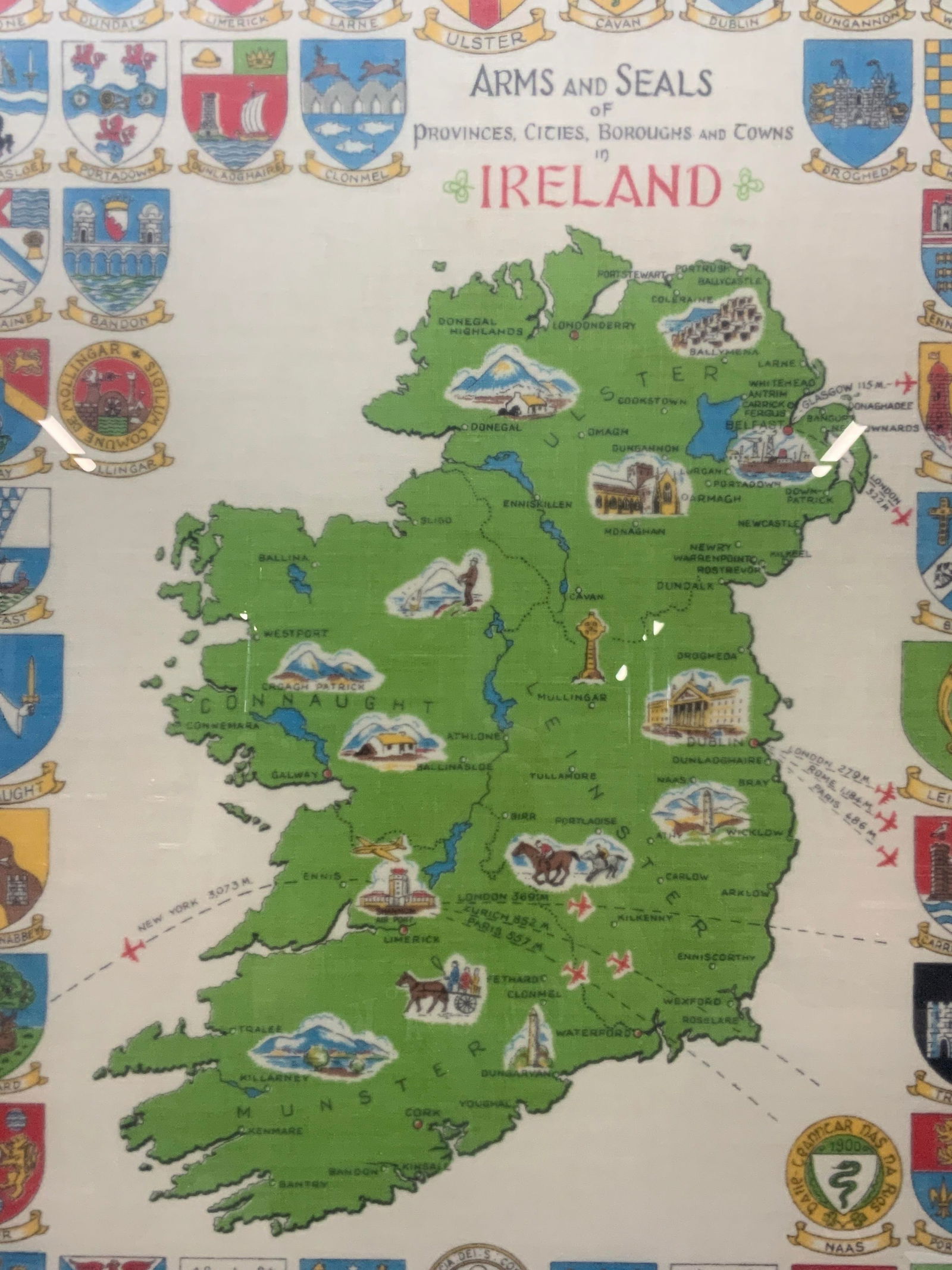 Arms & Seals of Ireland Fabric Art: Vintage fabric printed panel reading Arms and Seals on provinces, cities, boroughs and towns in Ireland. Depicts the various arms around a geographical map of Ireland. Framed in a black and leafed edg