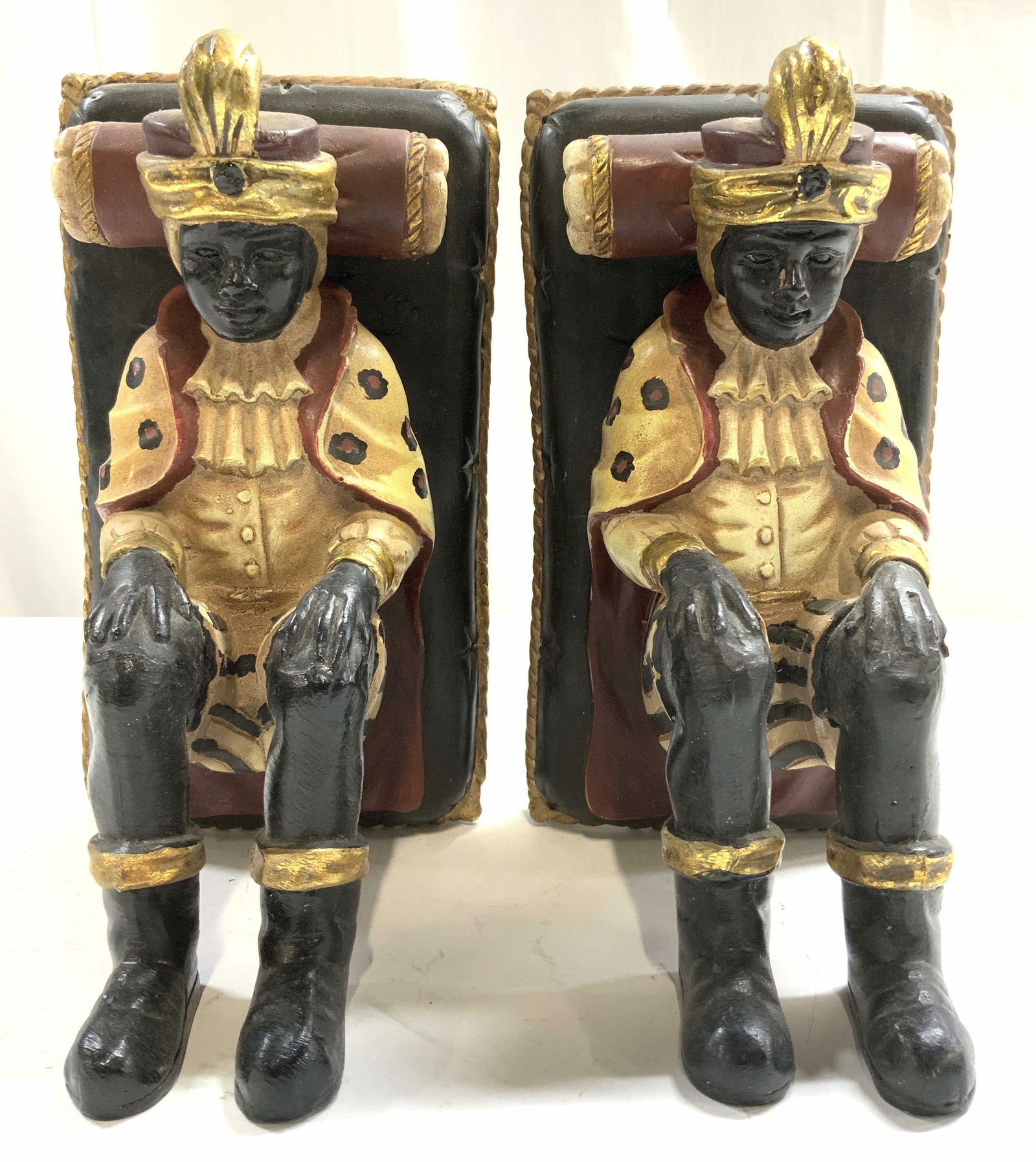 STERLING INDUSTRIES Pr Blackamoor Bookends: Tags on backside reads STERLING INDUSTRIES. Lot includes 2 bookends. Blackamoor style prince boy figure leaning on beds. Each piece appears to be wooden, possibly composite. Each bookend measures appr