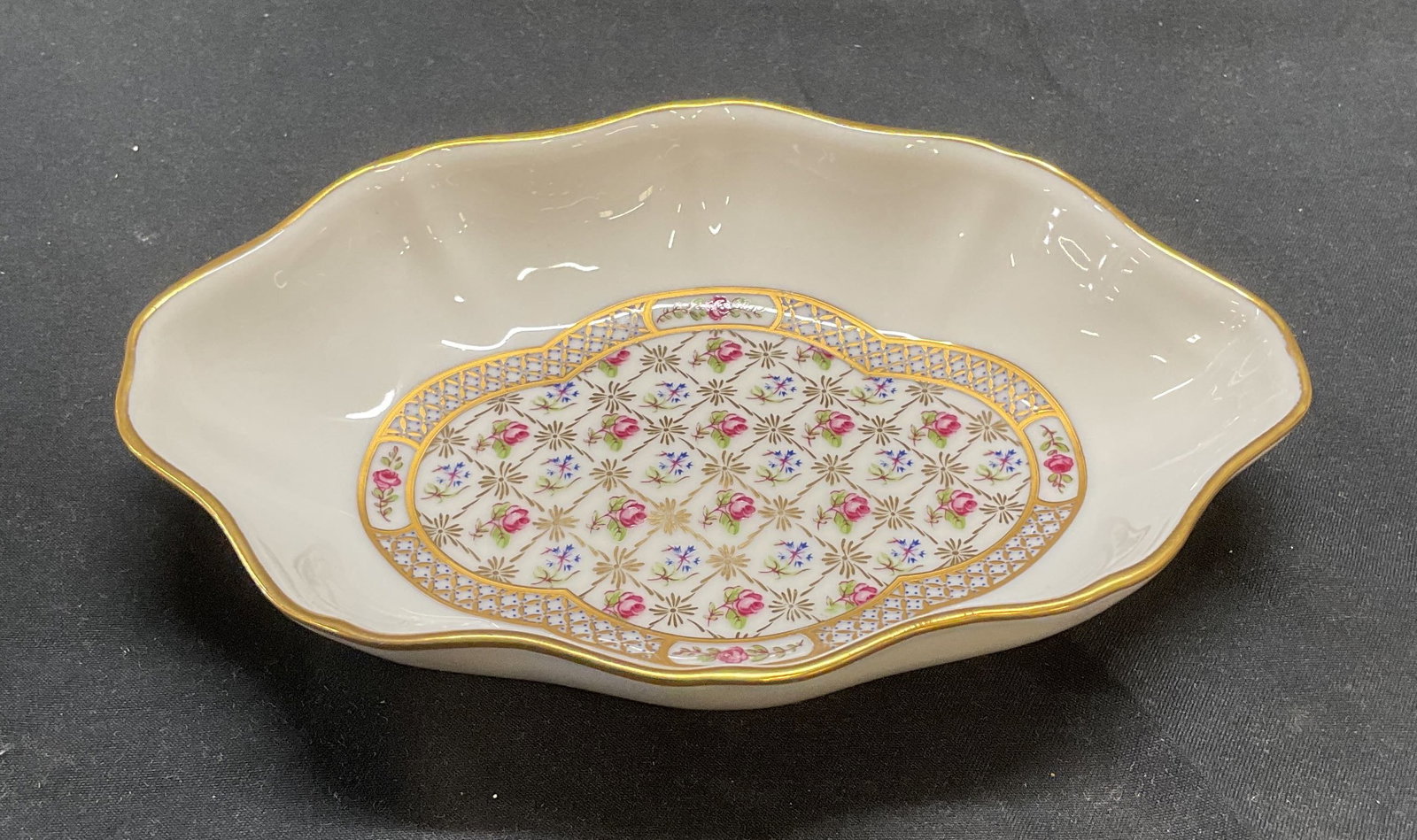 Limoges Castel Porcelain Floral Dish, France: Limoges Castel porcelain dish with hand painted floral motif and gilt decoration. Signed to underside. Made in France. Measures approx. 6 x 4 x 1 inches. Some surface wear including scratching observe