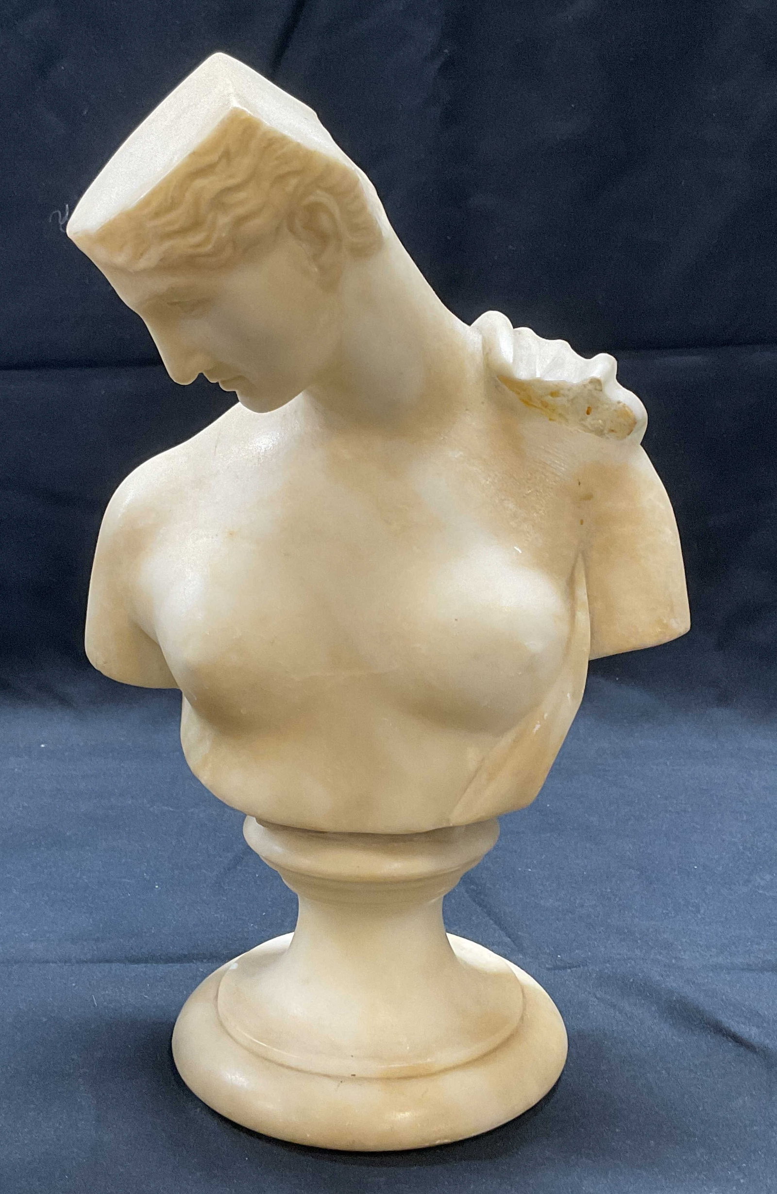 Vintage Carved Stone Bust of a Woman: Vintage carved stone bust of a woman. Measures approx. 6.5 x 4.5 x 11 inches. Piece is heavy. Not attached to base. Surface wear including scratching observed. Bust, stone bust, carved bust, bust of a