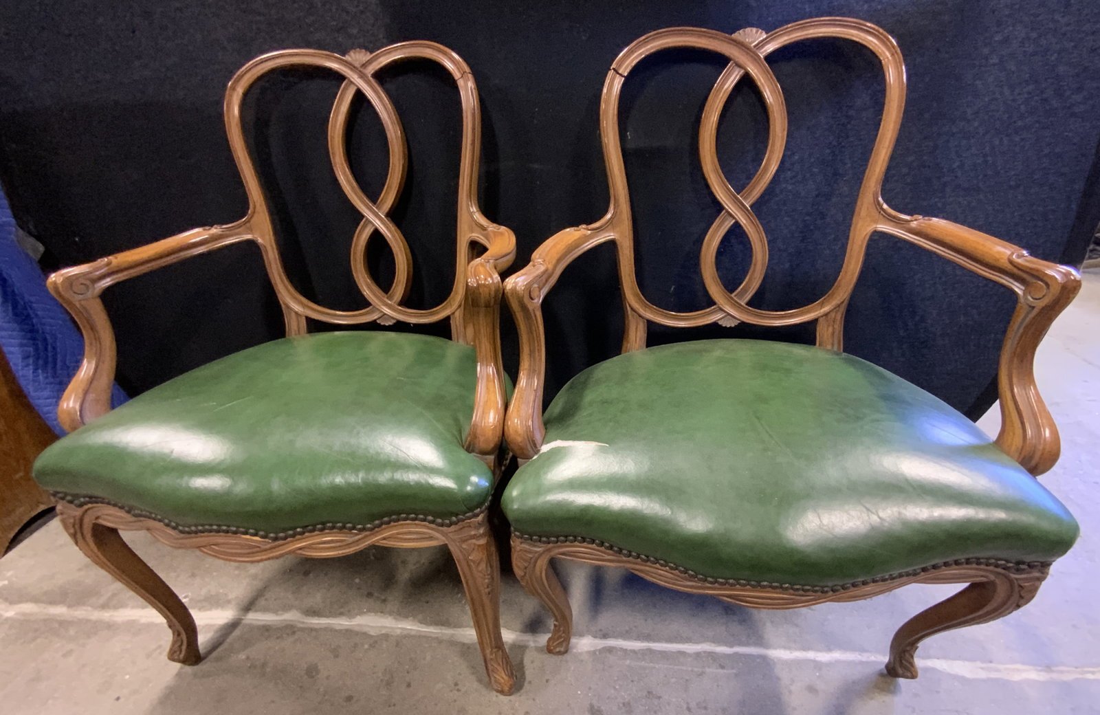 Pr Vntg Tangle Back Green Upholstery Side Chairs: A pair of vintage tangle back chairs with green upholstered seats. Seats appear to be upholstered with vinyl. Nail head accents. Measures approx. 36.5H x 24W x 19D in. Tears, separation, and surface w