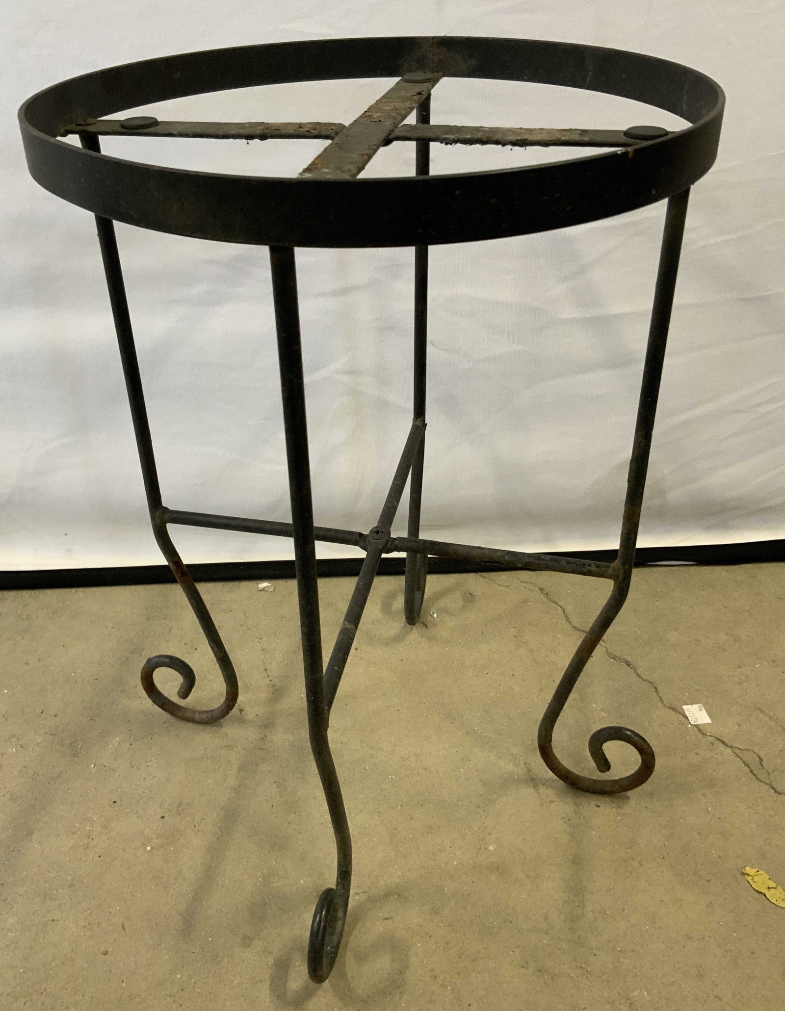 Vintage Black Iron Planter Stand W/ Scroll Feet: A vintage black metal, possibly iron, plant stand with scroll feet. Measures approx. 19H x 13.5W in. Surface wear consistent with age, use, and exposure. Losses to finish and discoloration present. Co