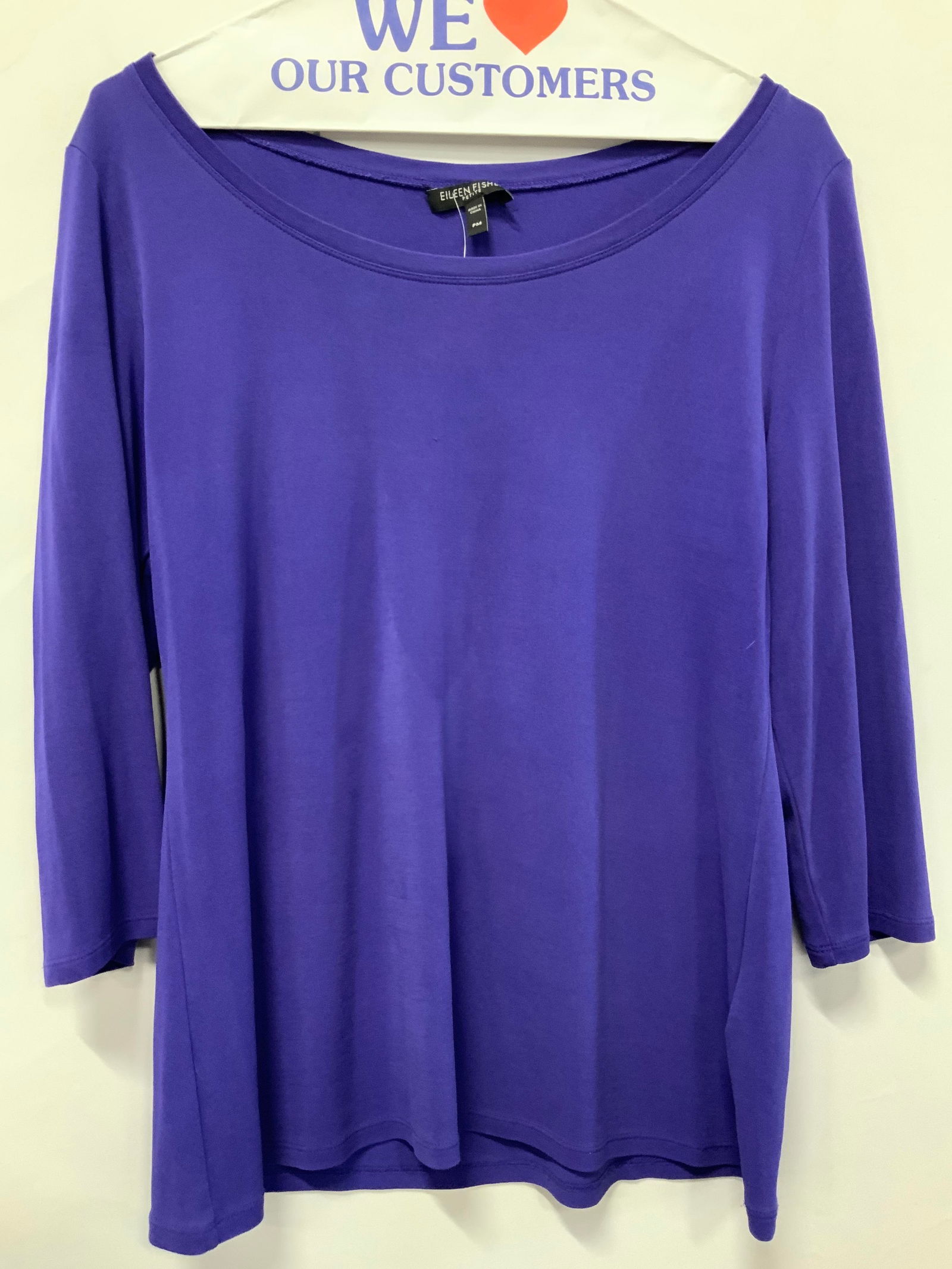 Eileen Fisher Silk Three Quarter Sleeve Shirt: Eileen fisher purple toned three quarter sleeve shirt with u neck line. Marked 100% Silk. Size Petite Medium. Sleeves measures 10 inches long, chest measures 18 inches across. Minor thread pulling to