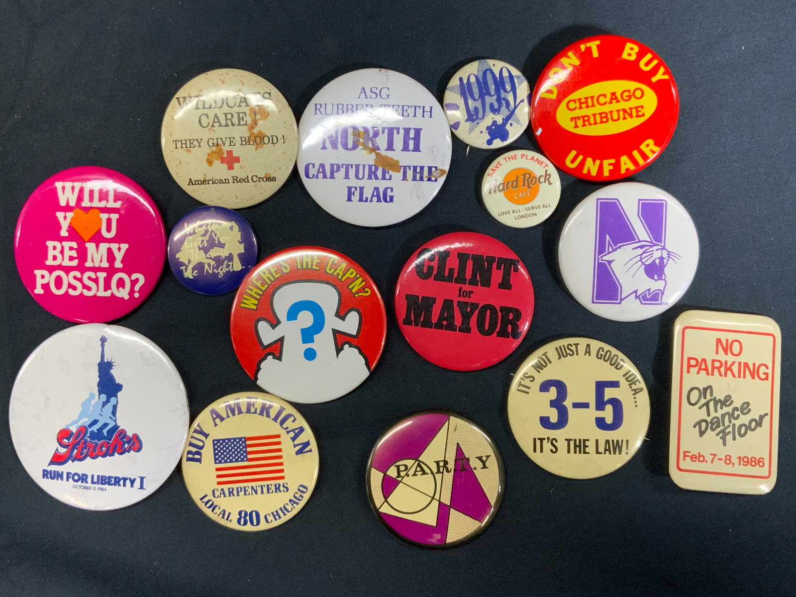 Lot15 Vintage Political & Community Pins: 15 Assorted vintage pins. Largest pin measures approx. 3 in Diameter. Pins vary in purpose and message. Political, union, schools, culture. One rectangular pin. Many have foxing and patina. All have b
